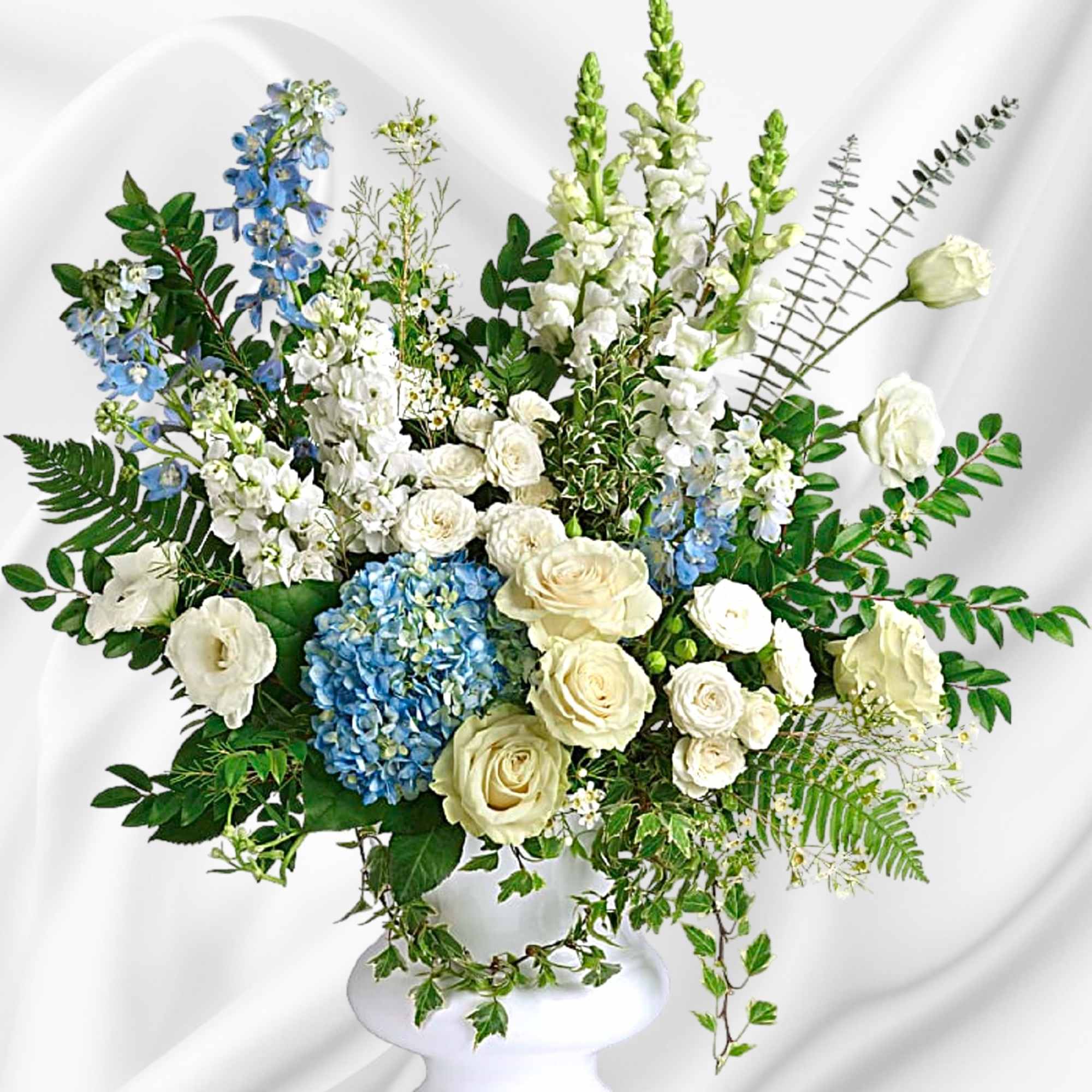 White and blue floral arrangement in a white pedestal vase, photo 2 of 4