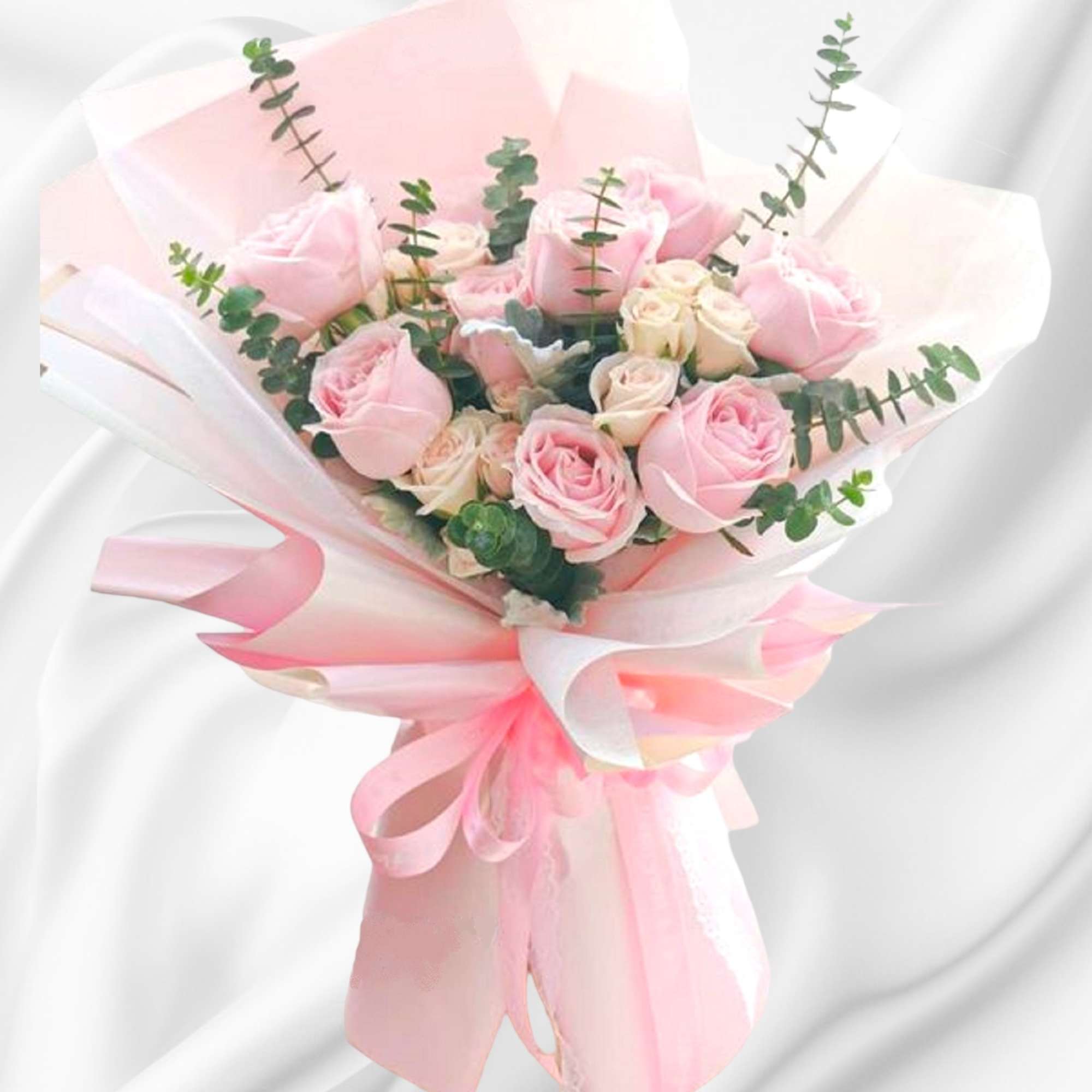 Pink rose bouquet wrapped in pale pink and white paper