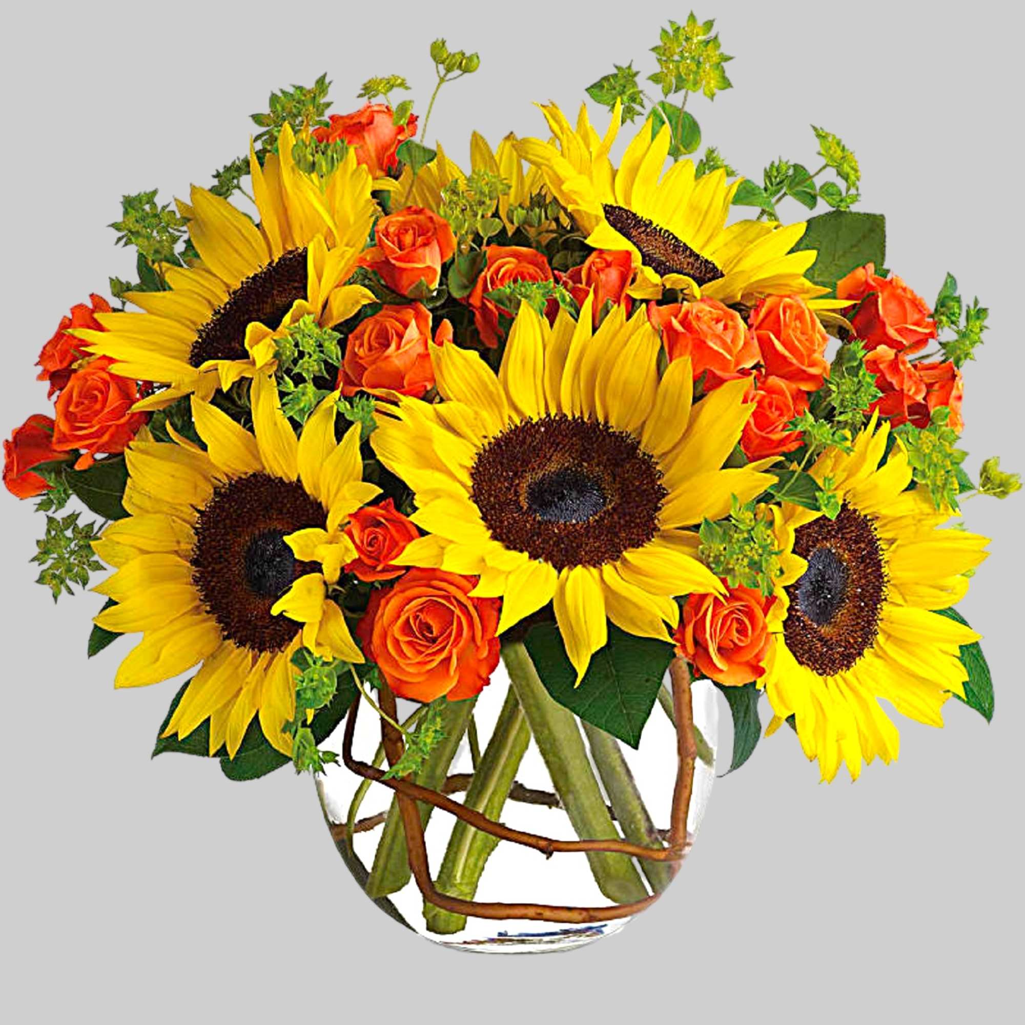 Sunflower and orange rose bouquet in a clear glass vase