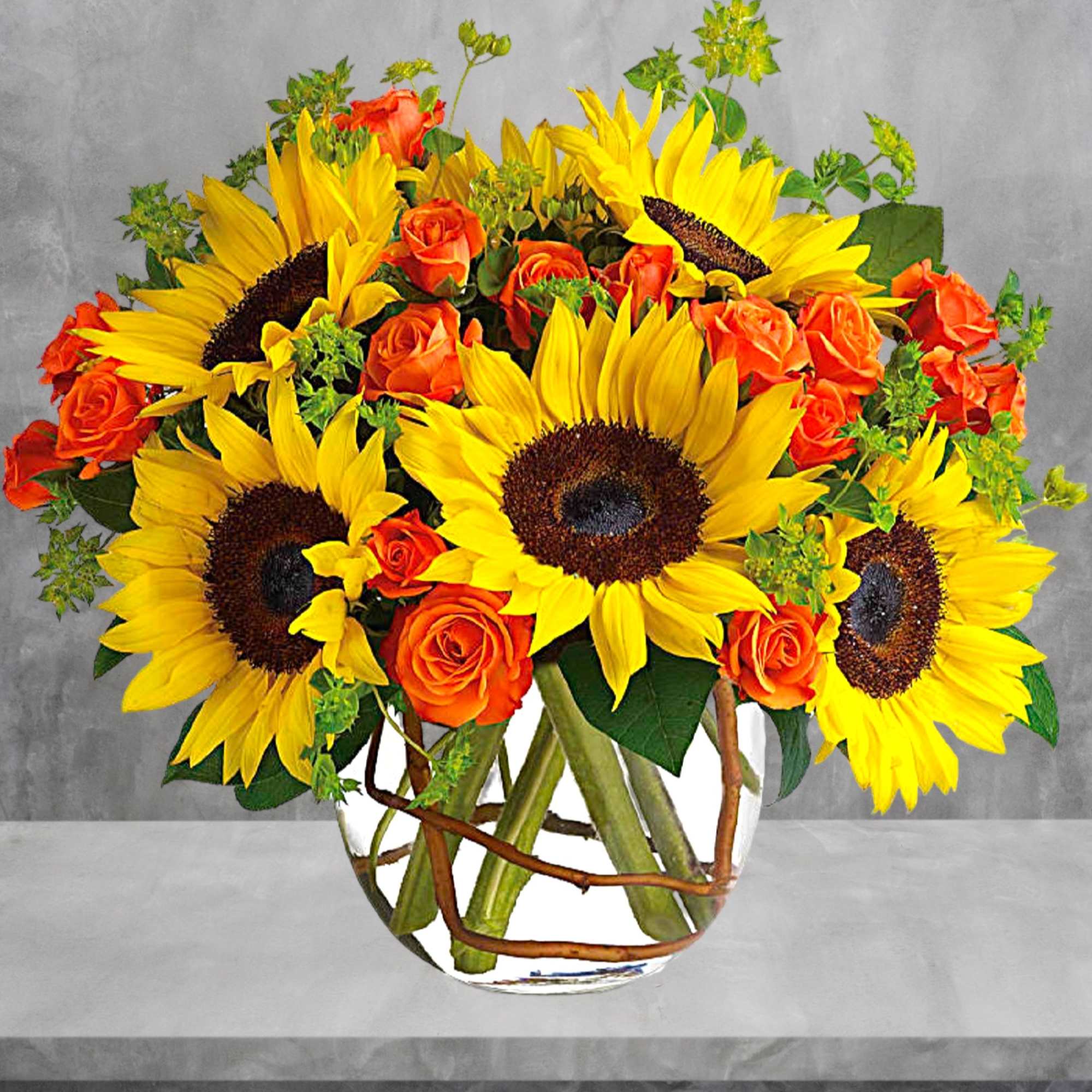 Sunflowers and orange roses arranged in a clear glass vase, photo 3 of 6