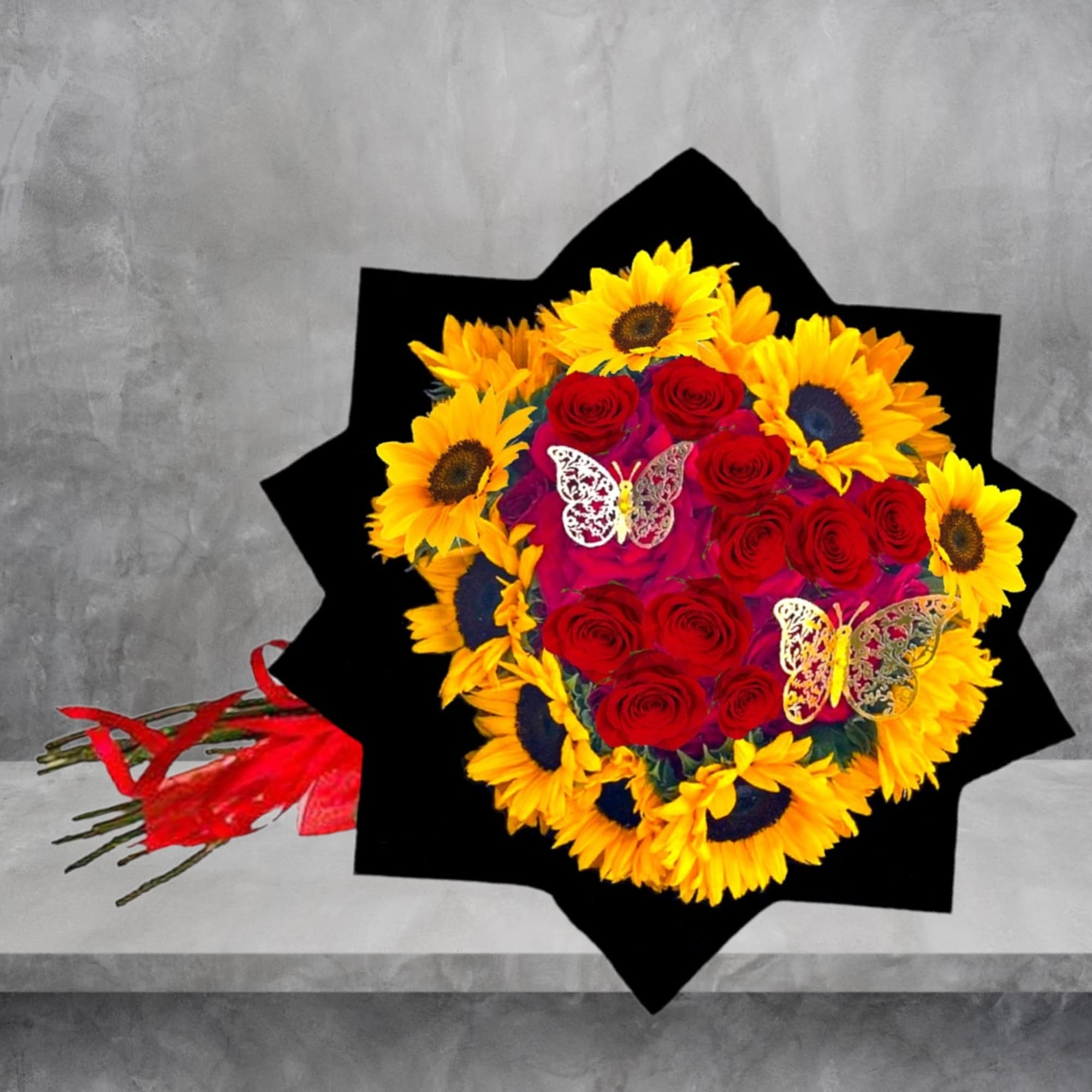 Bouquet of red roses and yellow sunflowers with butterfly decorations