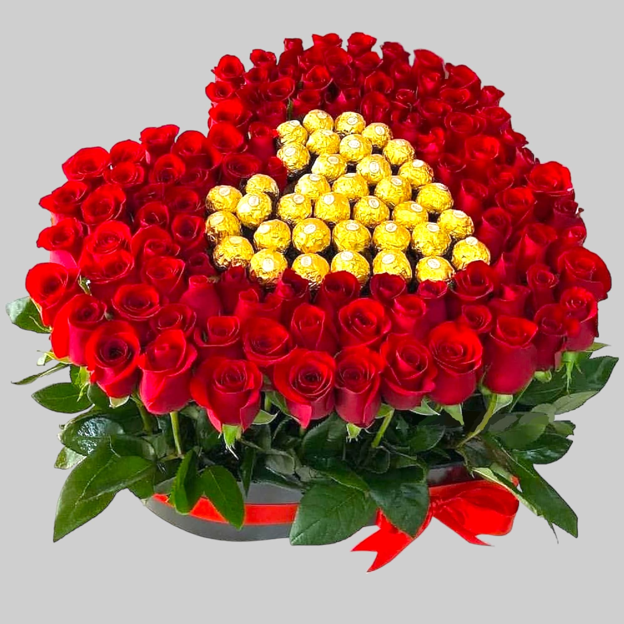Round bouquet of red roses with gold-wrapped chocolates in the center