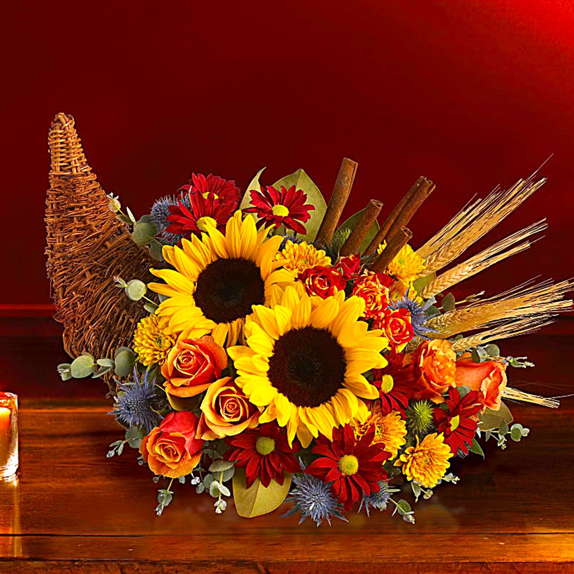 Sunflower and rose arrangement in a wicker cornucopia basket