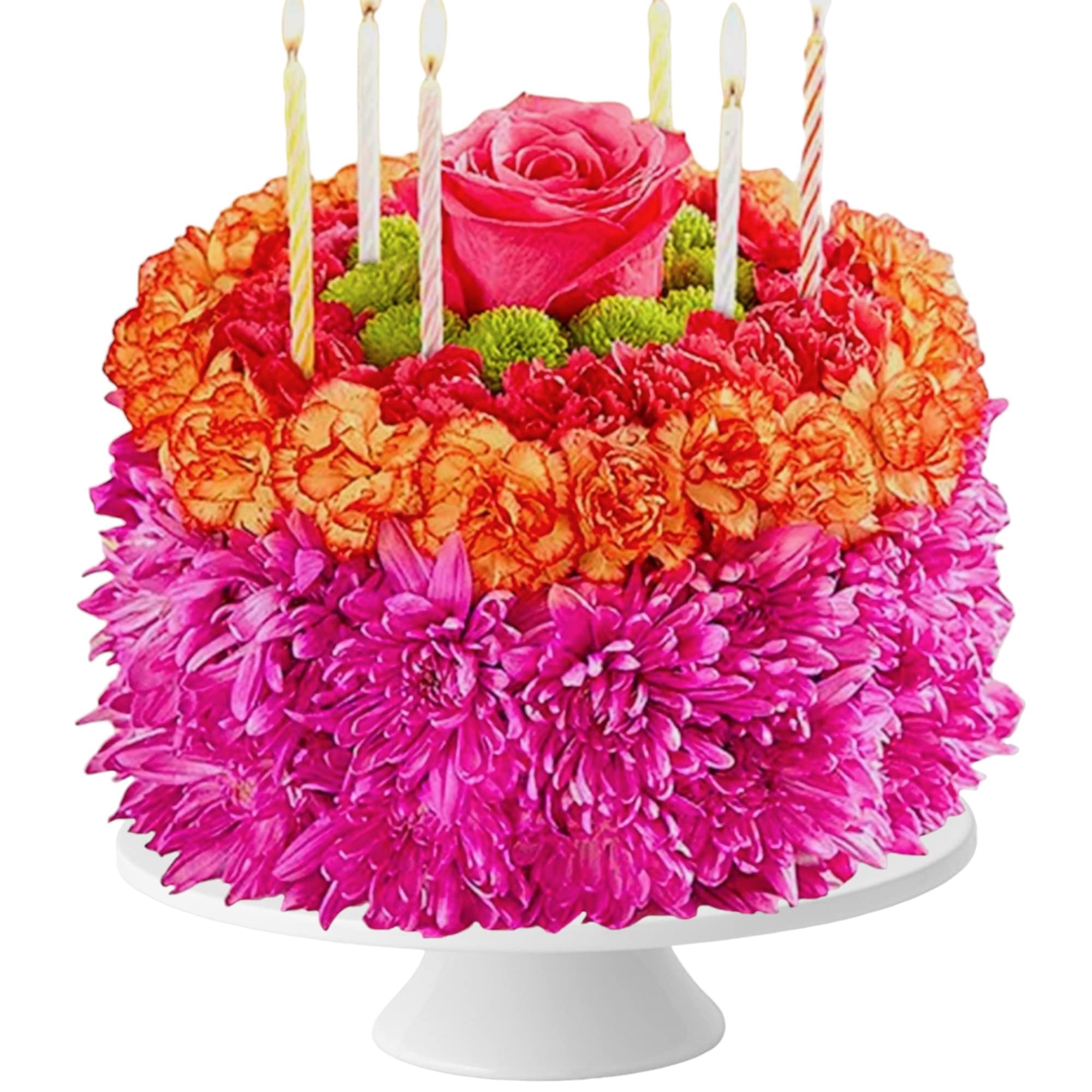 Flower cake with pink roses, orange carnations, and striped candles on a white stand