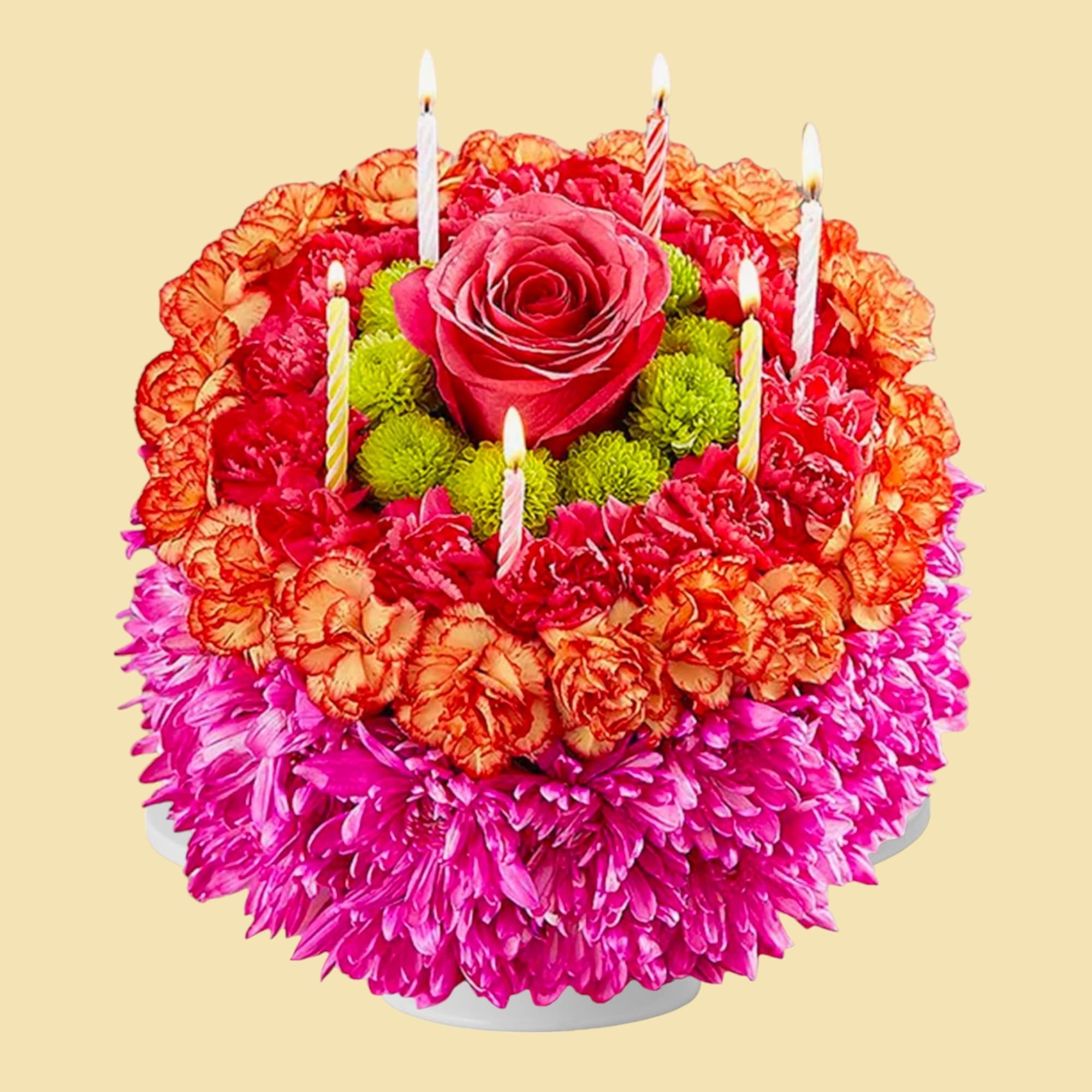 Round floral cake with a rose center and lit candles