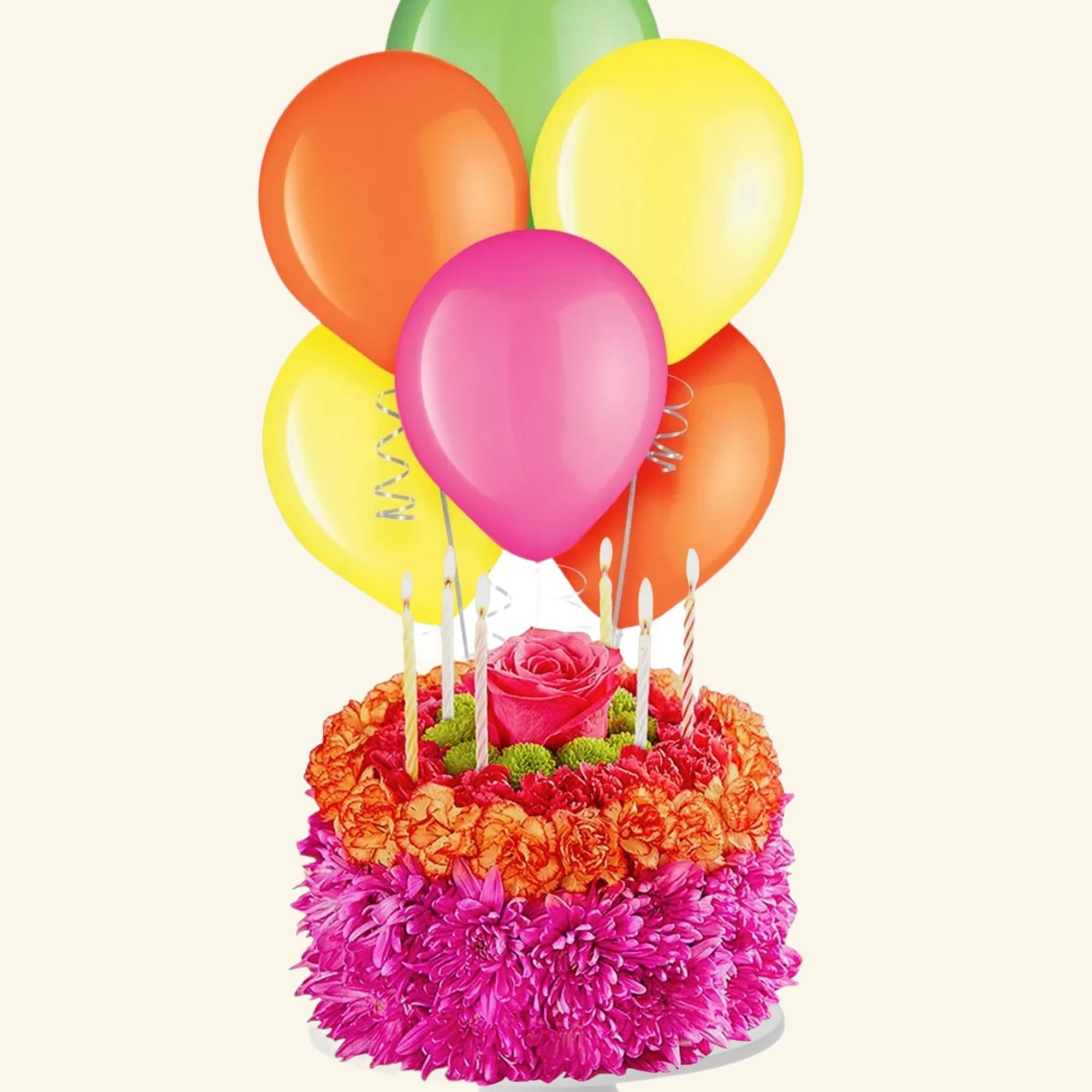 Flower cake with balloons and candles on a pedestal stand