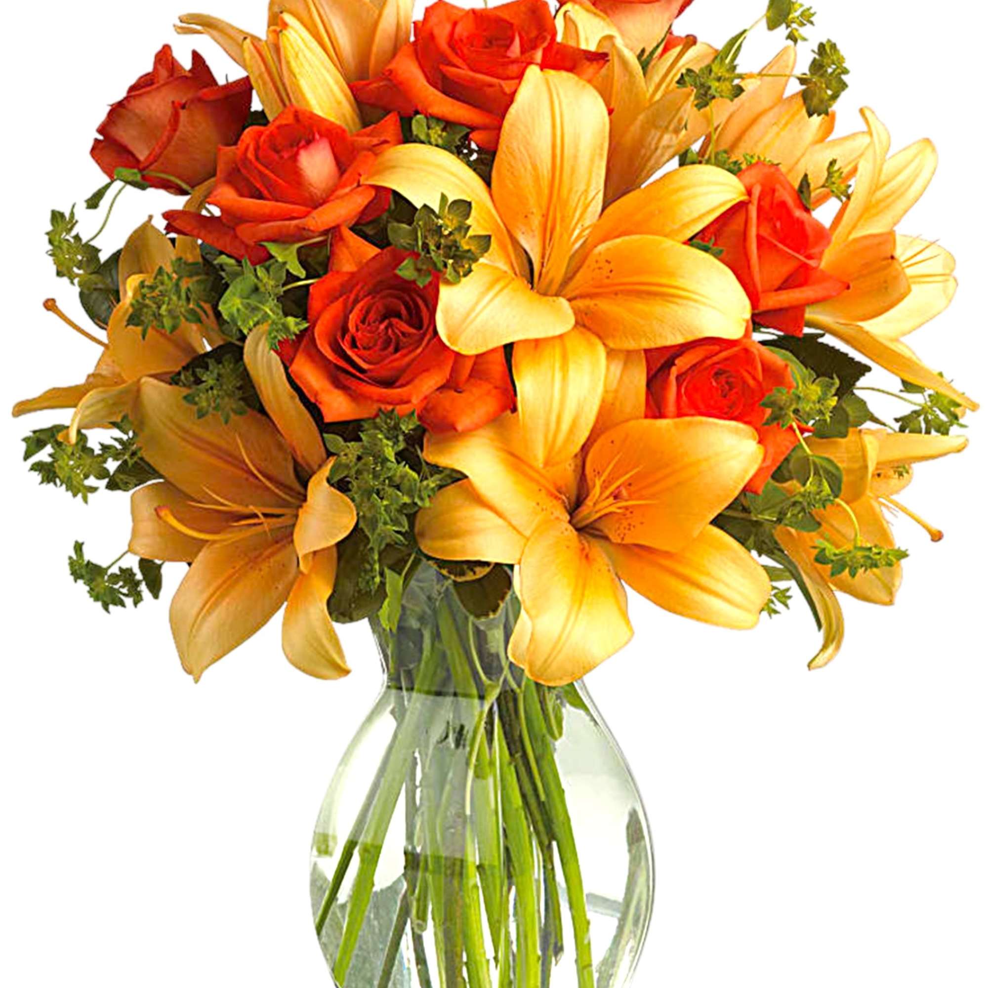 Bouquet of orange roses and yellow lilies in a clear glass vase