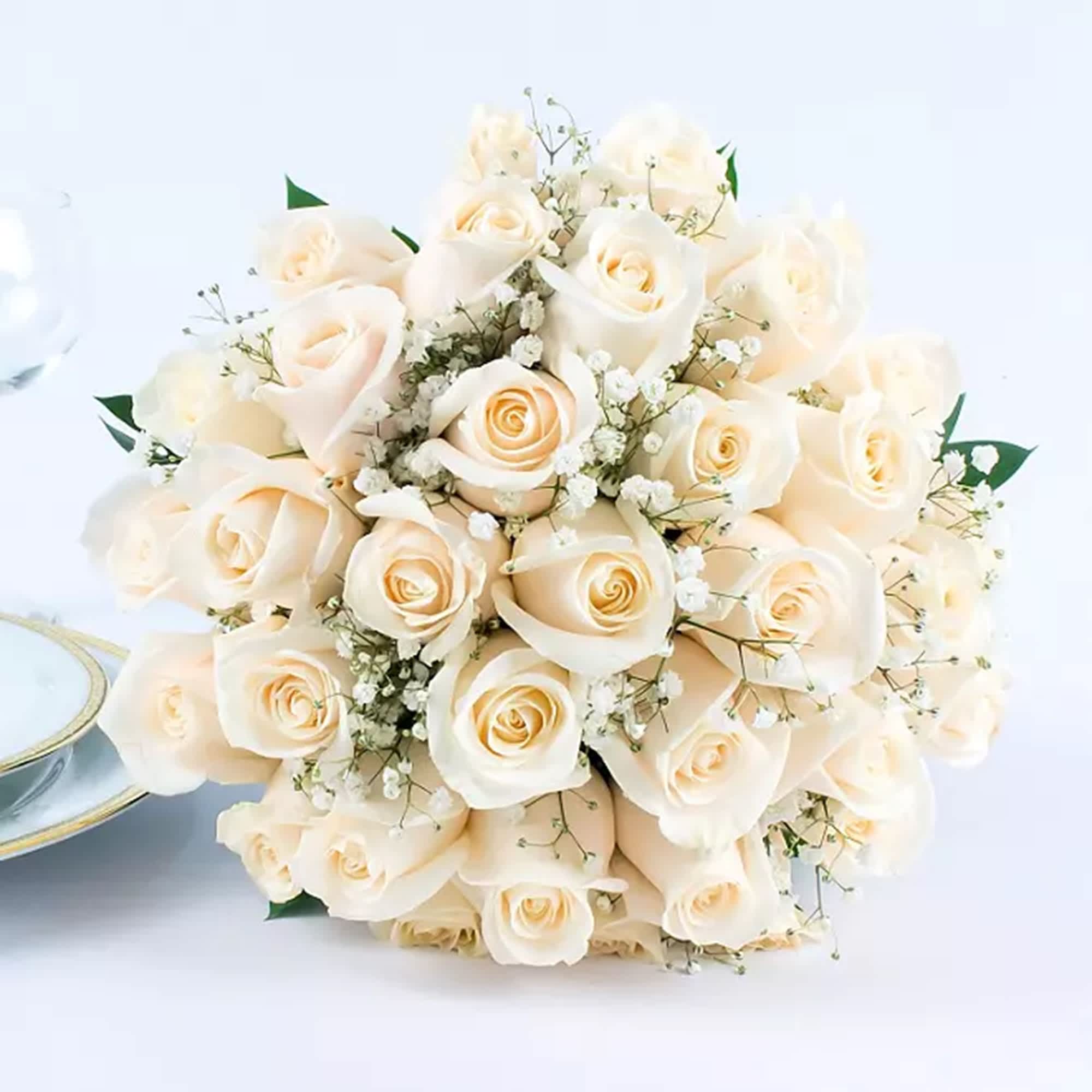 Bouquet of ivory roses with baby's breath on a white background