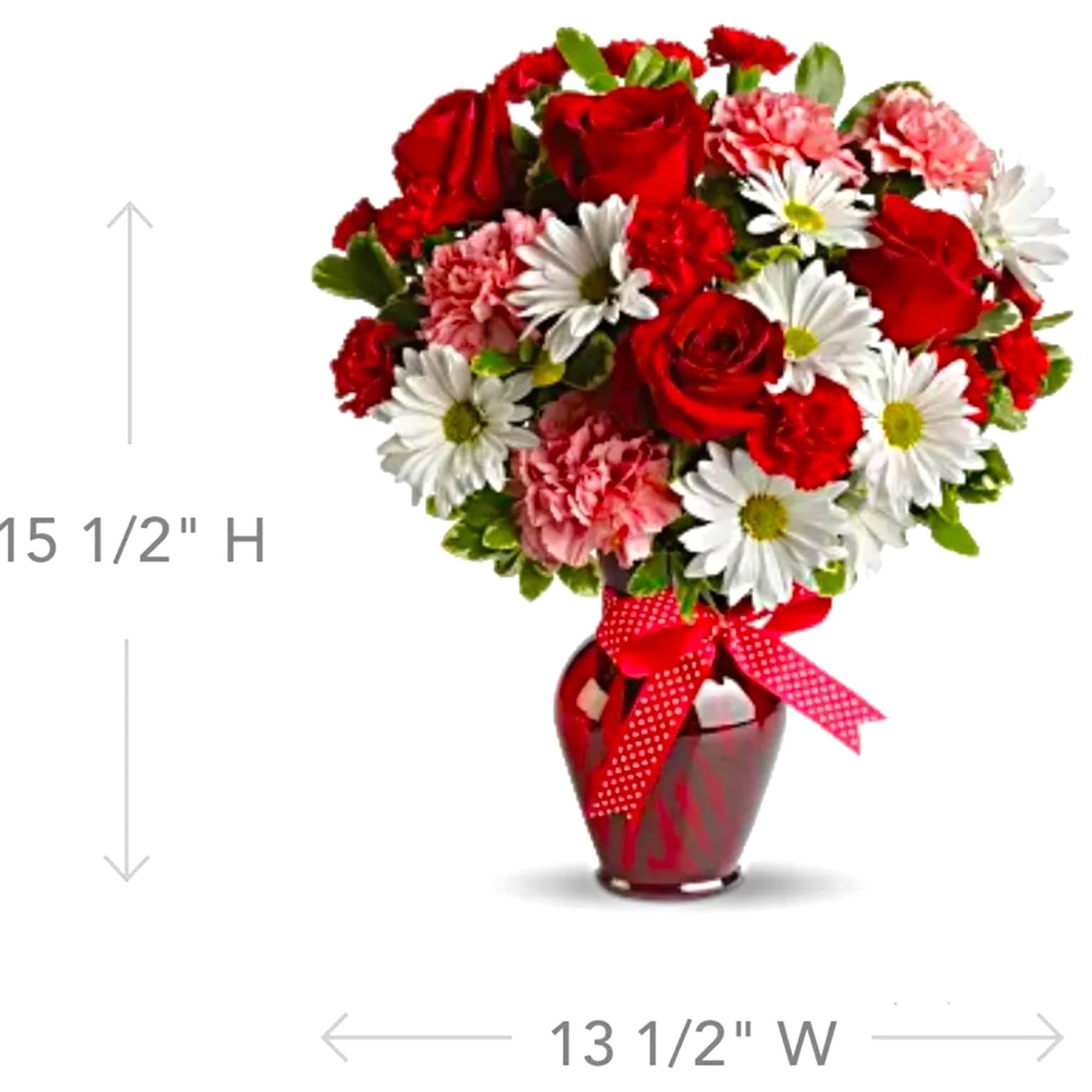 Bouquet of red roses, pink carnations, and white daisies in a red vase