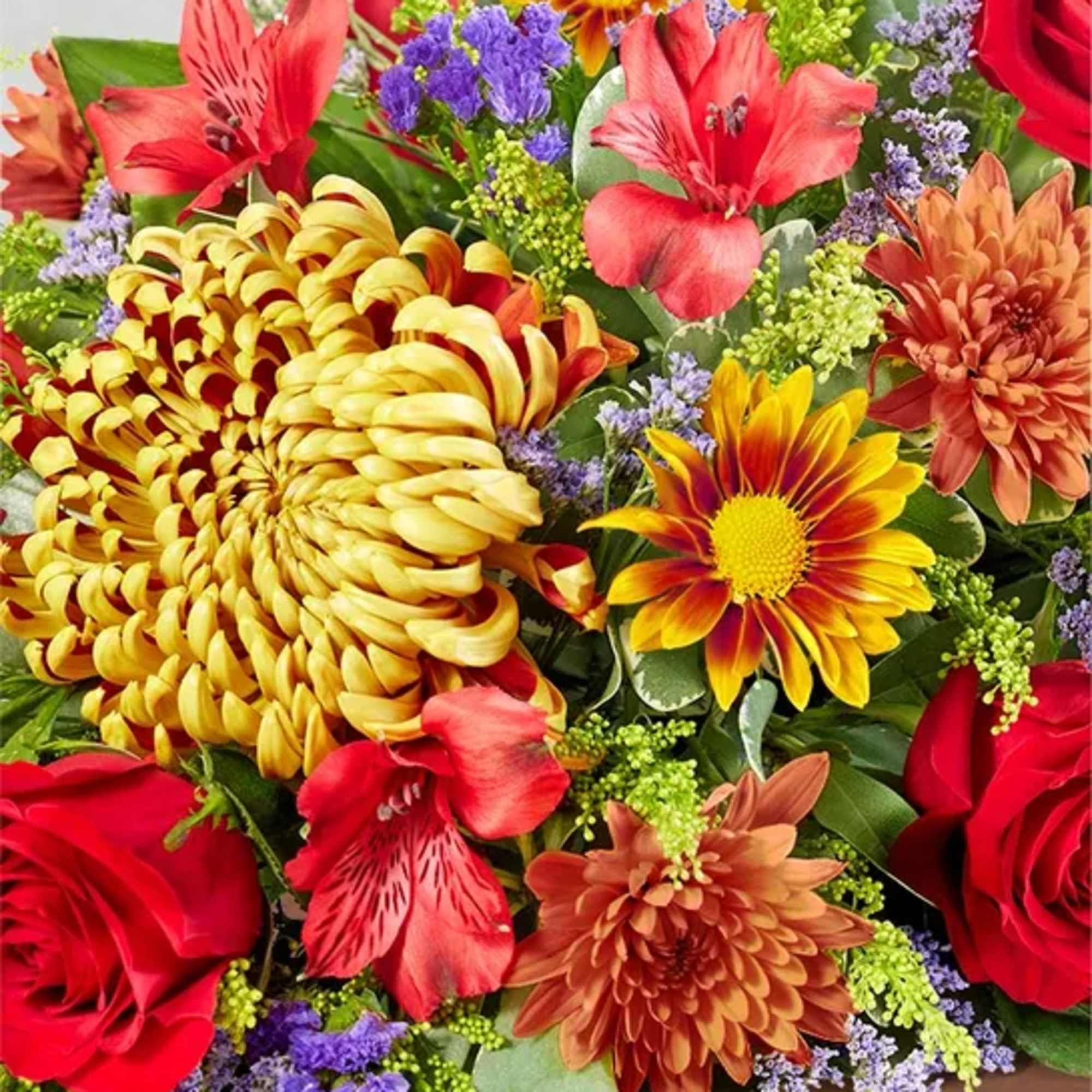 Mixed bouquet with red roses, yellow chrysanthemums, and red alstroemeria