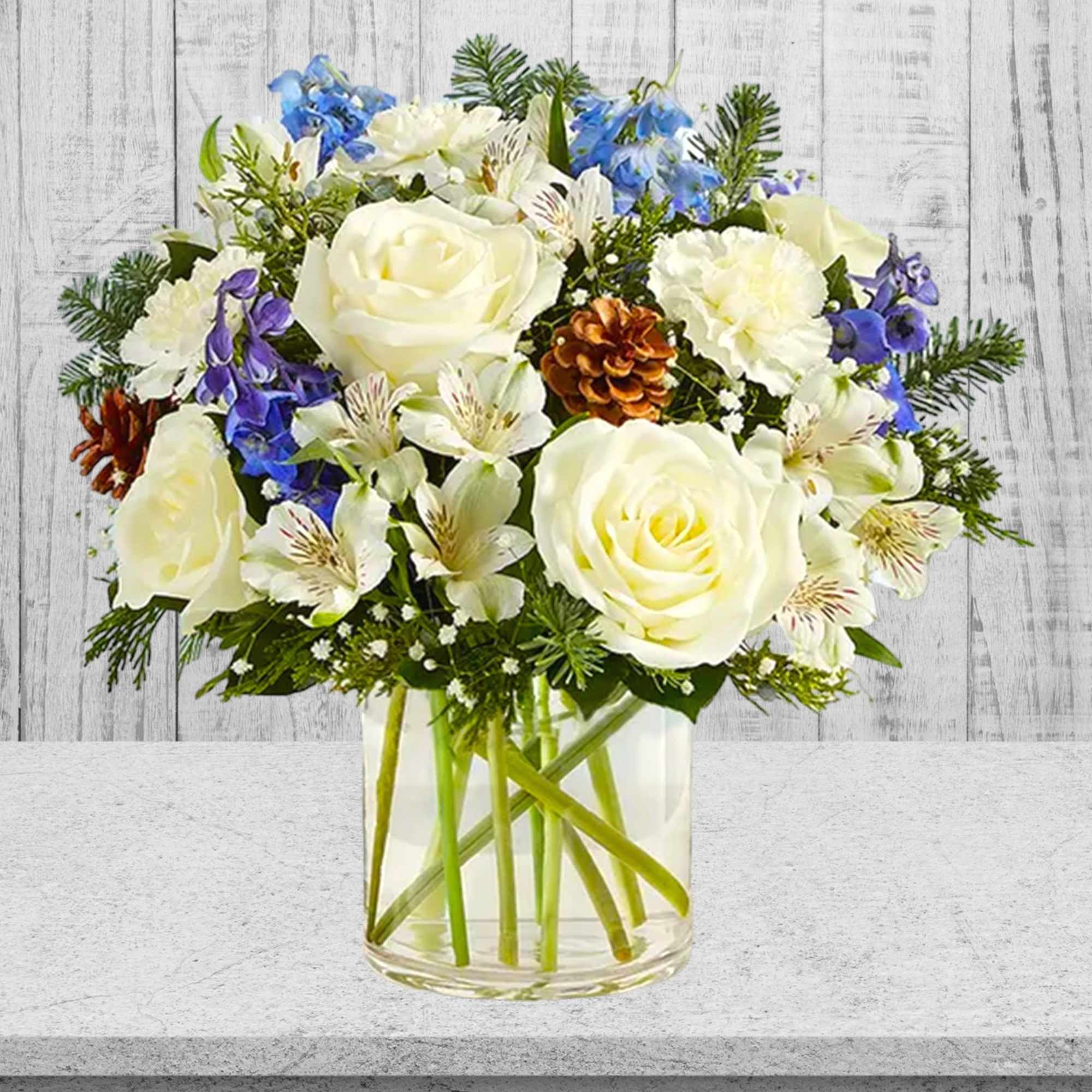 White roses and blue flowers arranged in a clear glass vase, photo 4 of 4