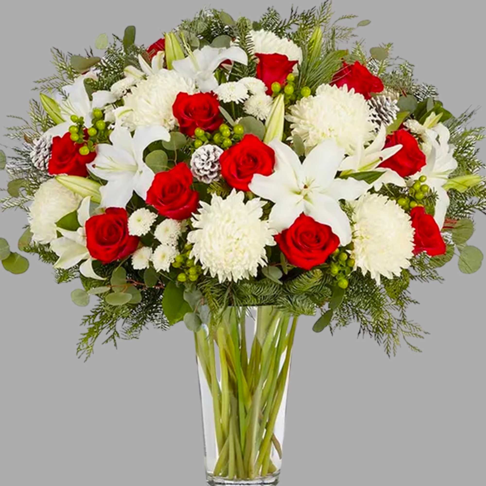Bouquet of red roses and white lilies in a clear glass vase
