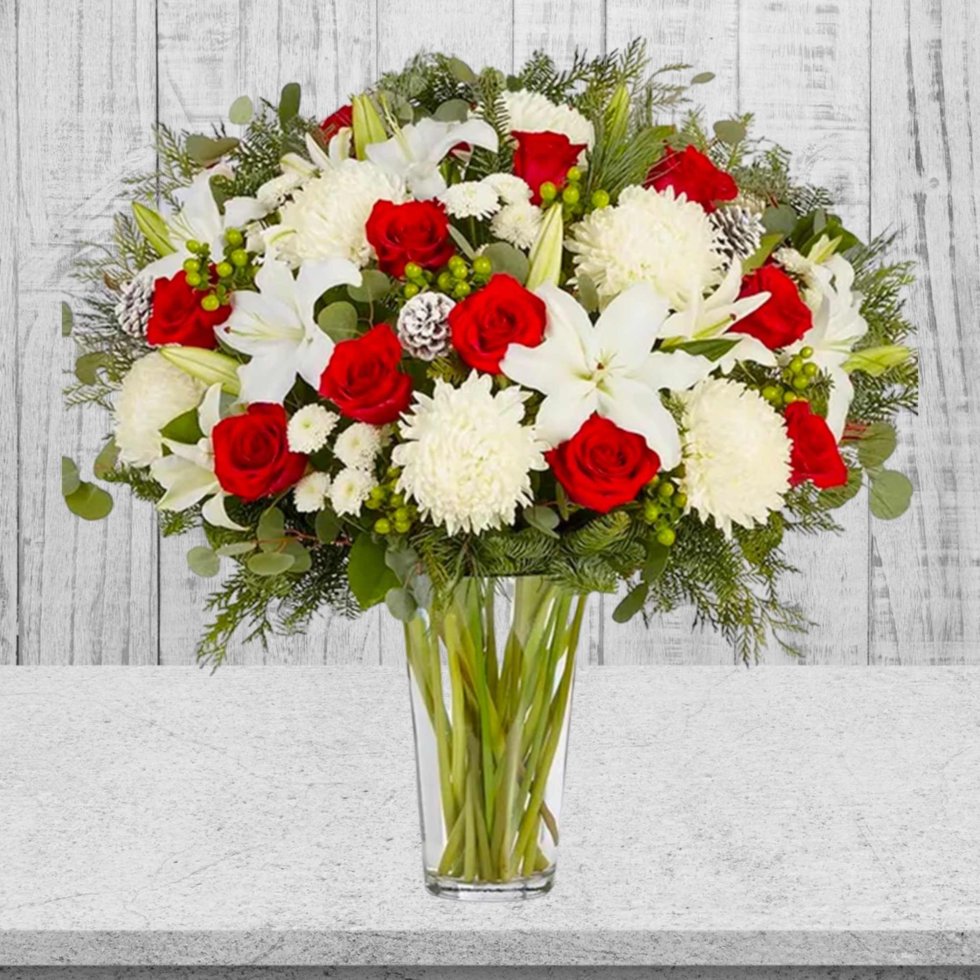 Red roses and white lilies in a clear glass vase, photo 3 of 4