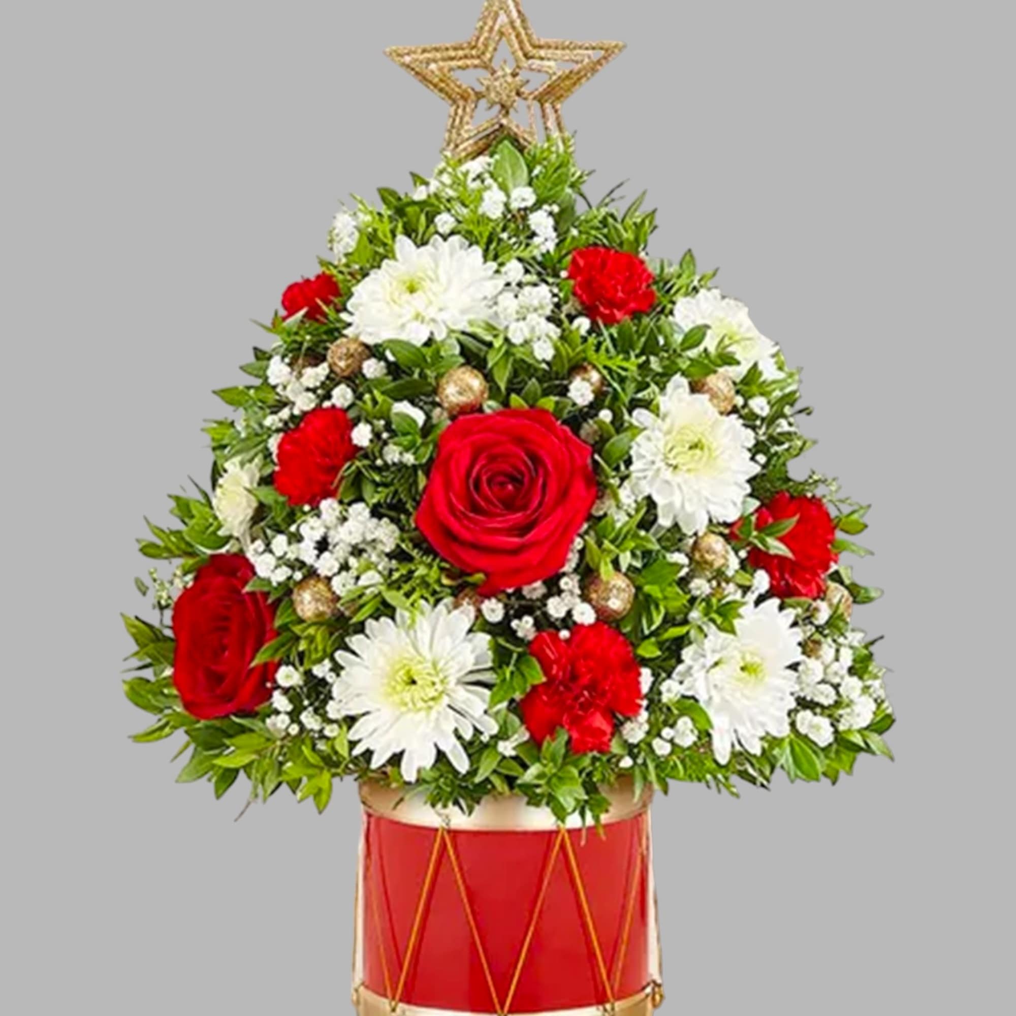 Christmas tree-shaped floral arrangement in a red drum container with a star topper