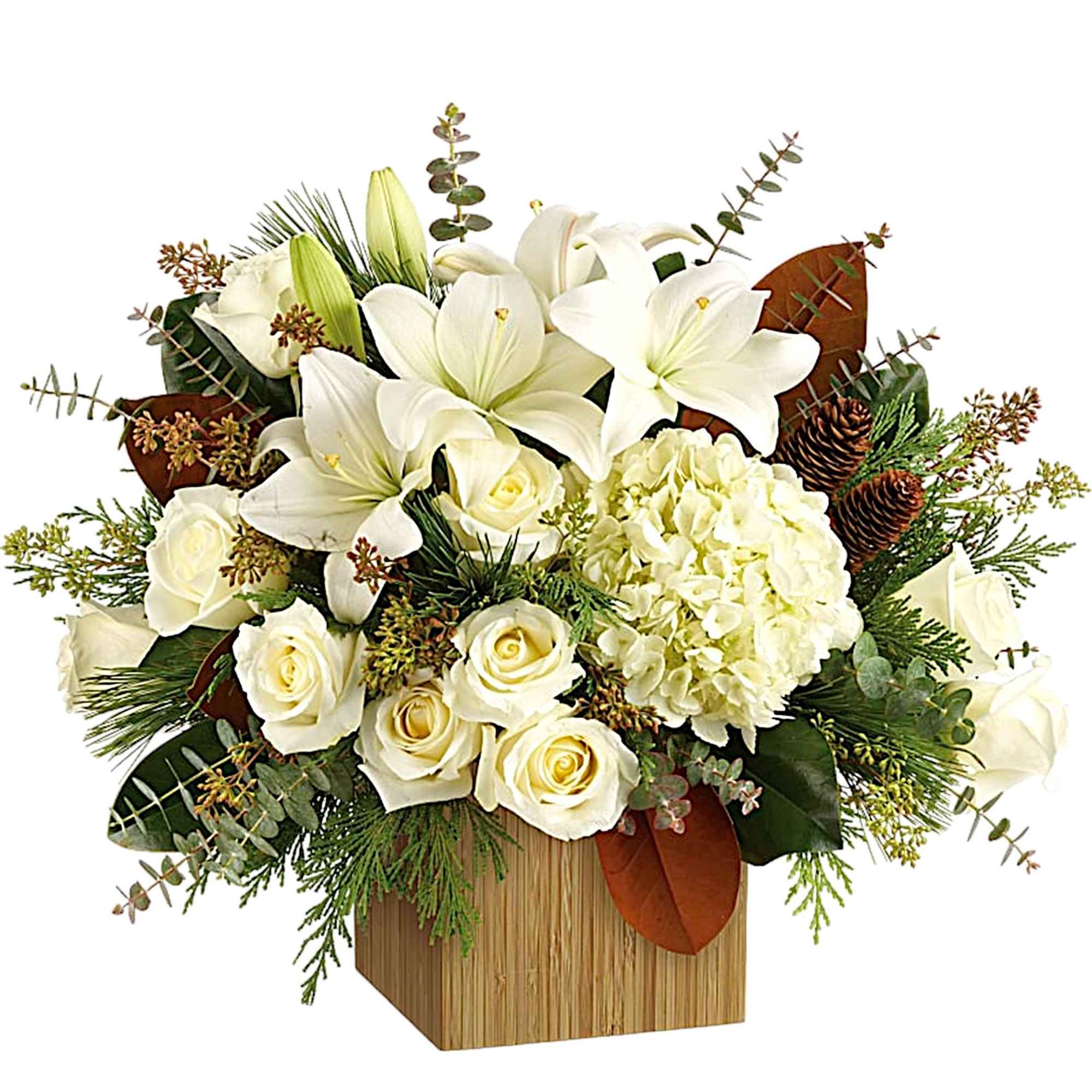 White lilies and roses arranged in a wooden box with greenery