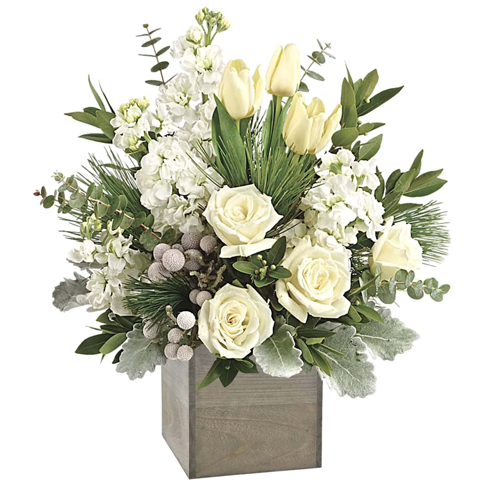 White roses and pale tulips in a wooden cube vase