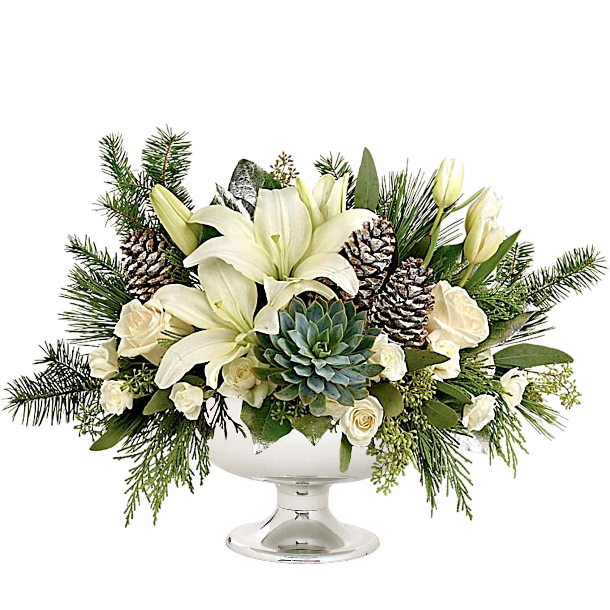 White lilies and roses in a glass pedestal bowl with pinecones