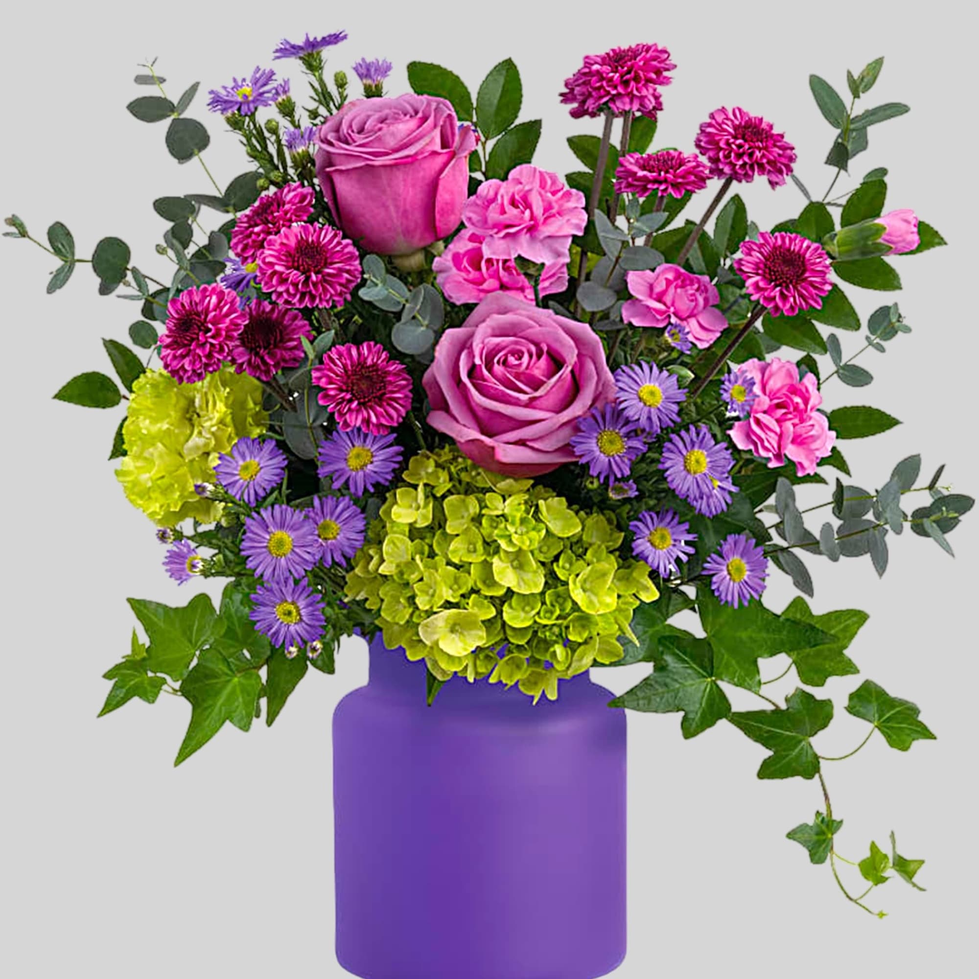 Pink and purple mixed bouquet in a purple vase, photo 2 of 3
