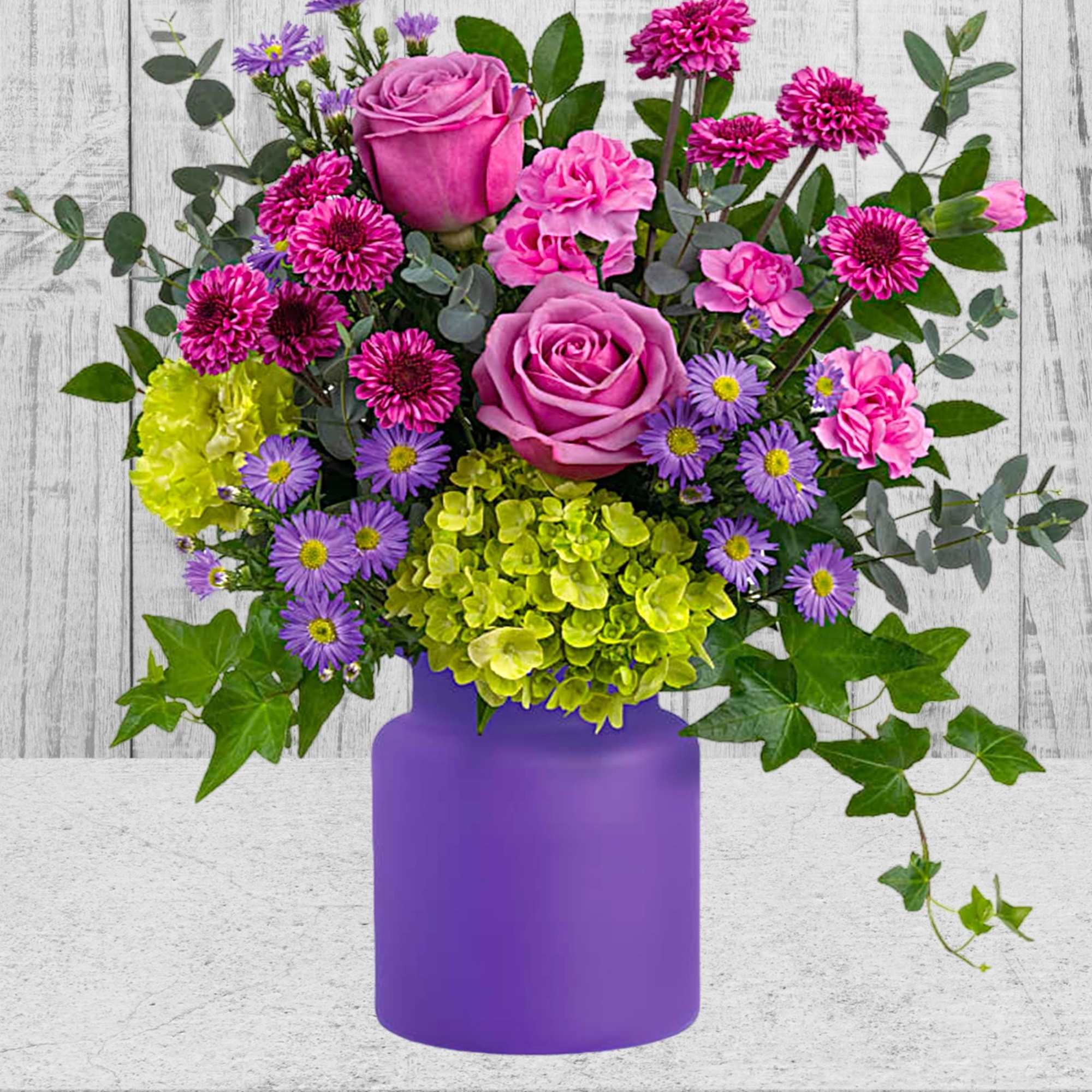 Pink and purple mixed bouquet in a purple vase, photo 3 of 3