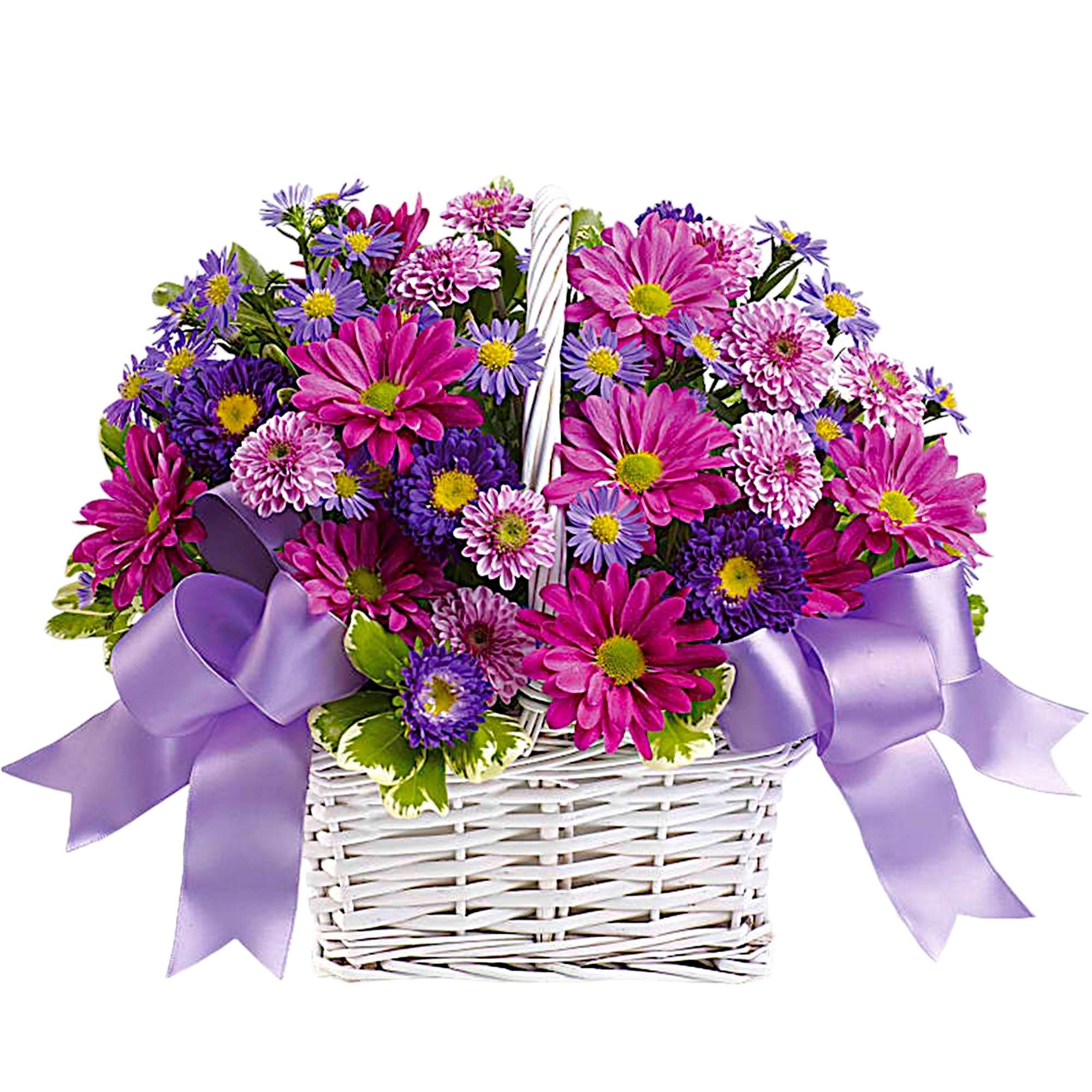 Pink and purple flowers in a white wicker basket with lavender ribbons