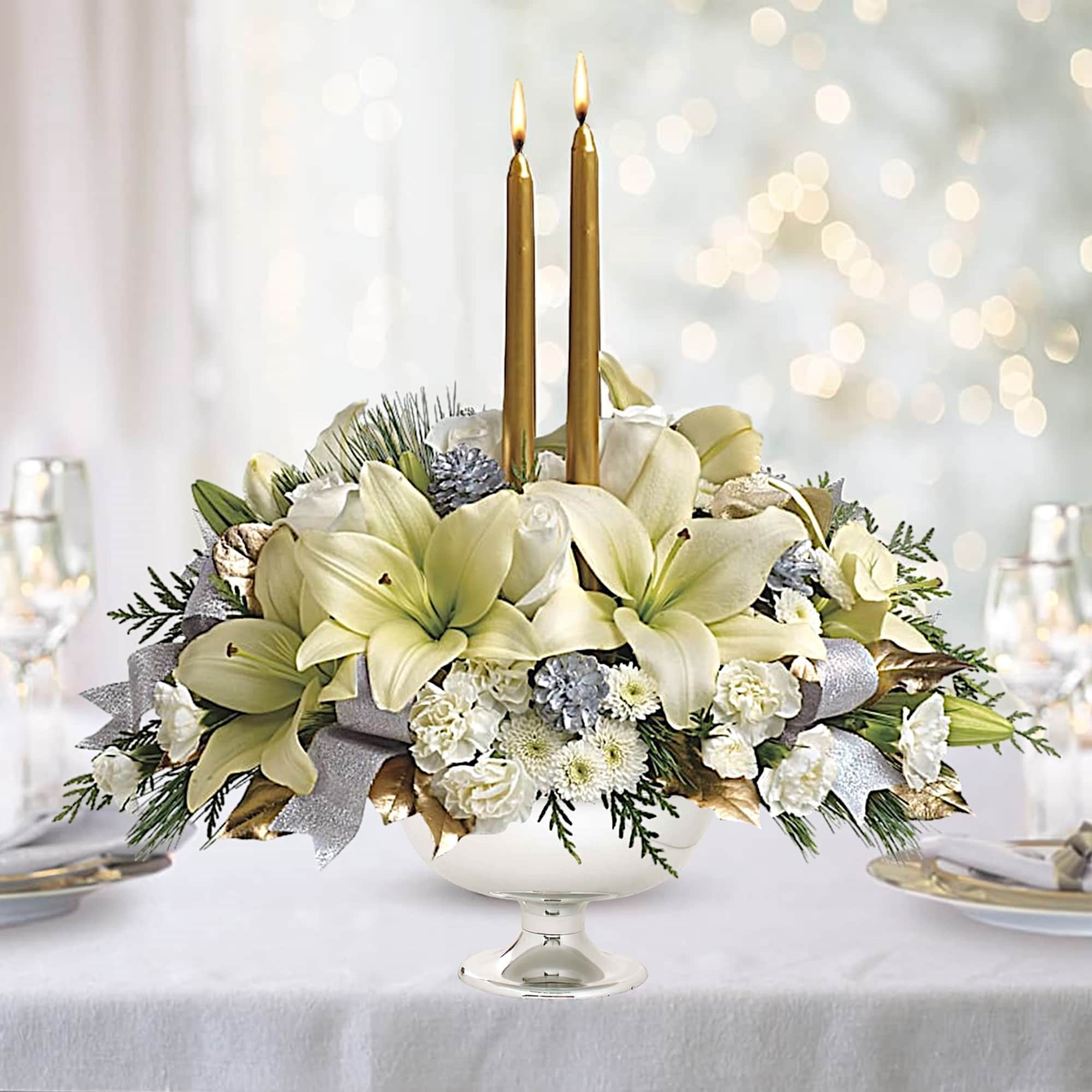 White floral centerpiece with two gold taper candles in a glass pedestal bowl, photo 4 of 4