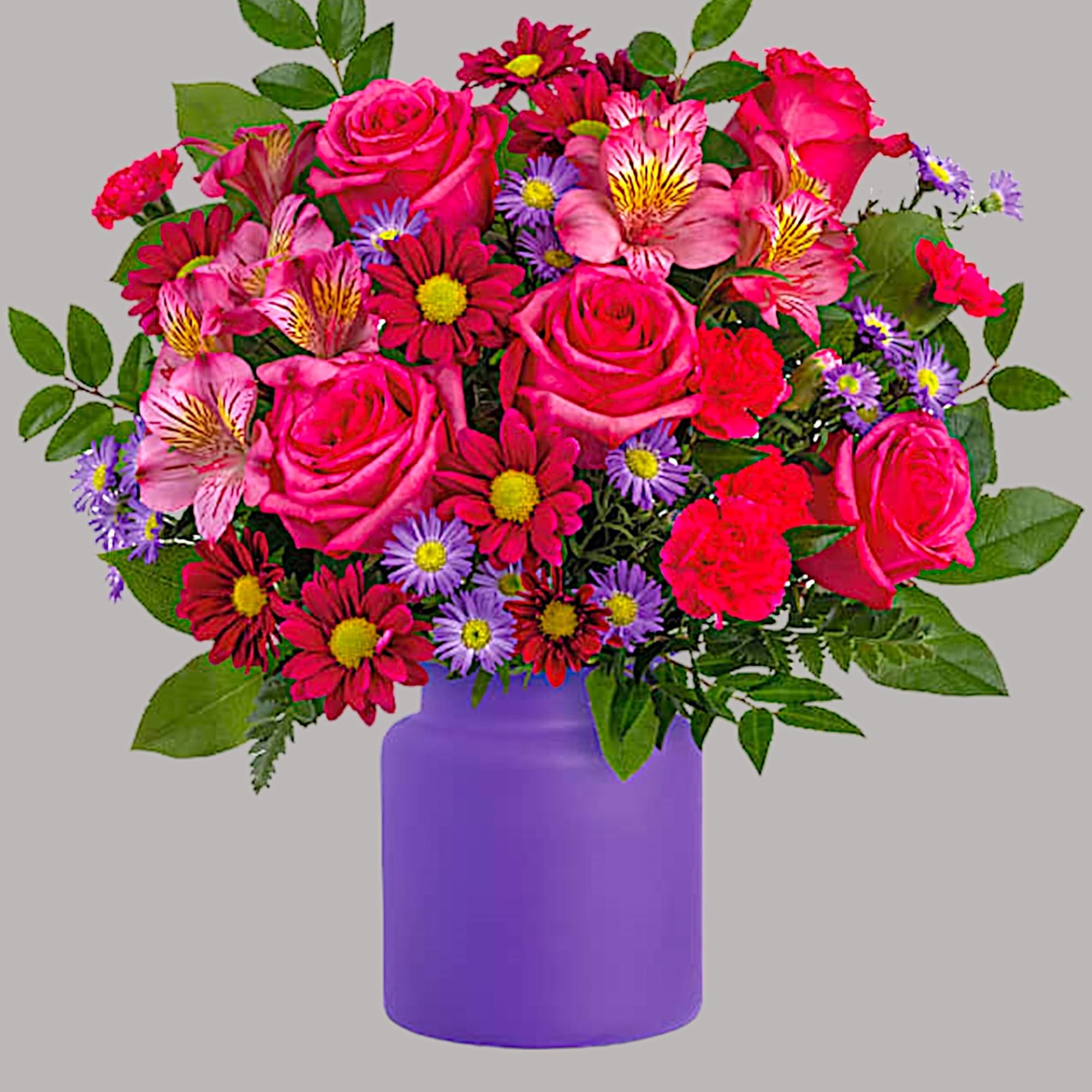 Mixed pink and purple flower bouquet in a purple vase