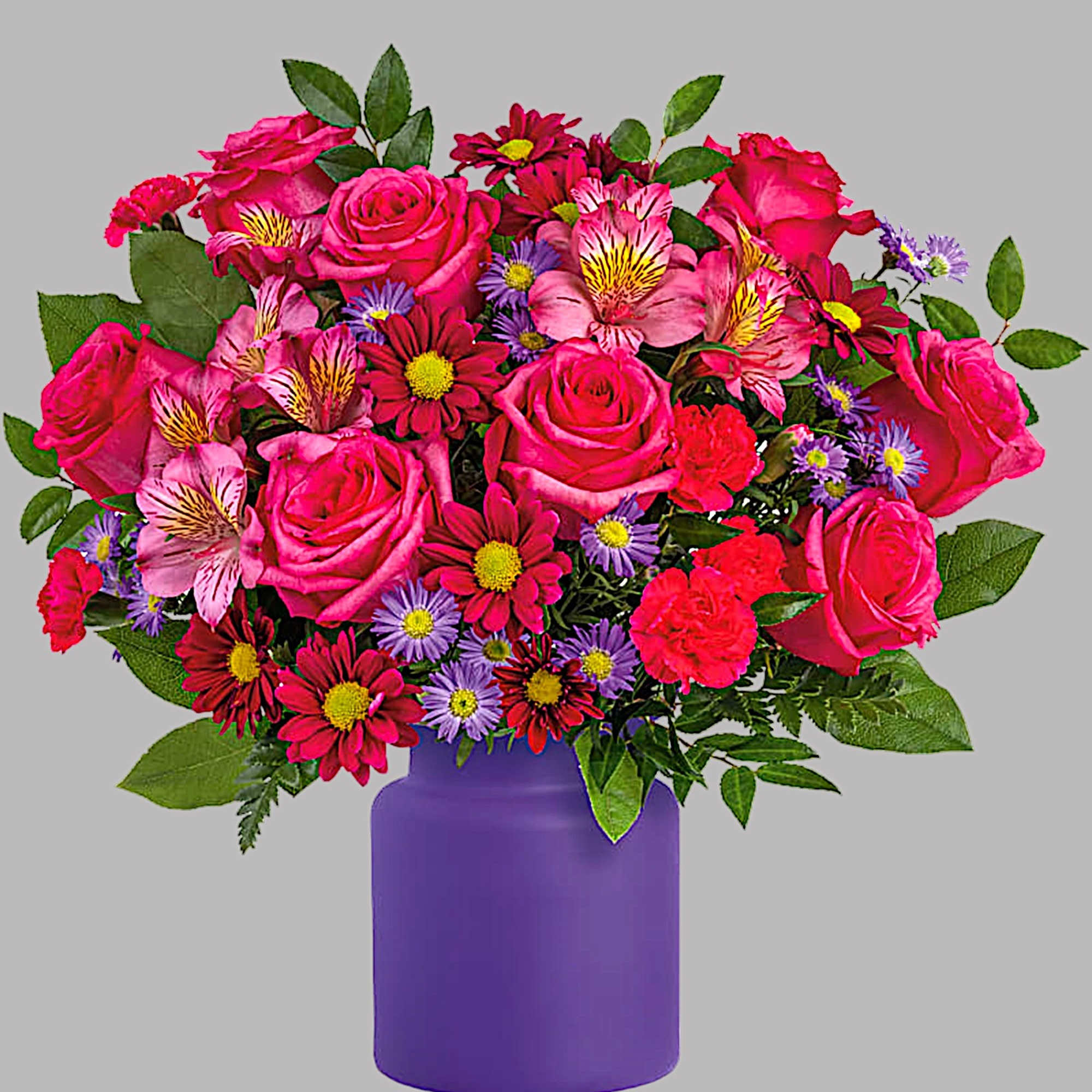 Mixed bouquet of pink roses and daisies in a purple vase