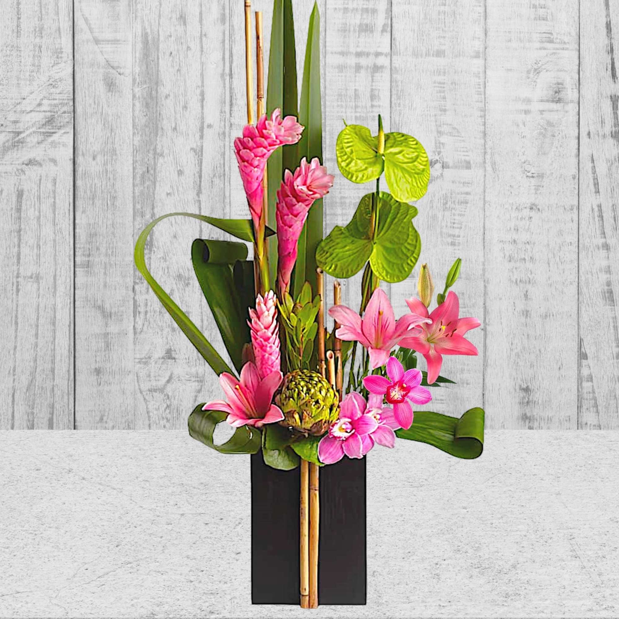 Pink tropical flowers arranged in a tall black vase