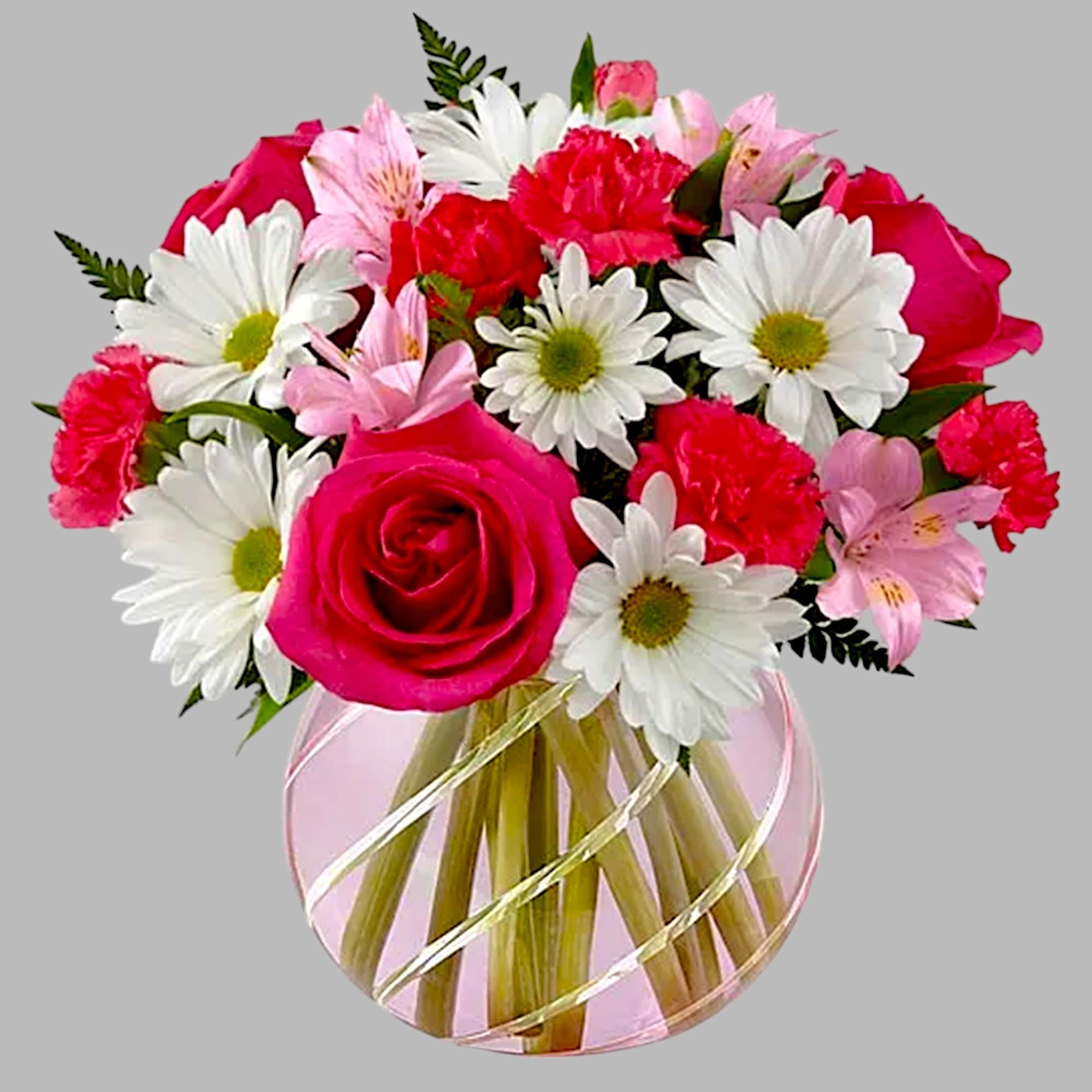 Pink roses and white daisies arranged in a round glass vase