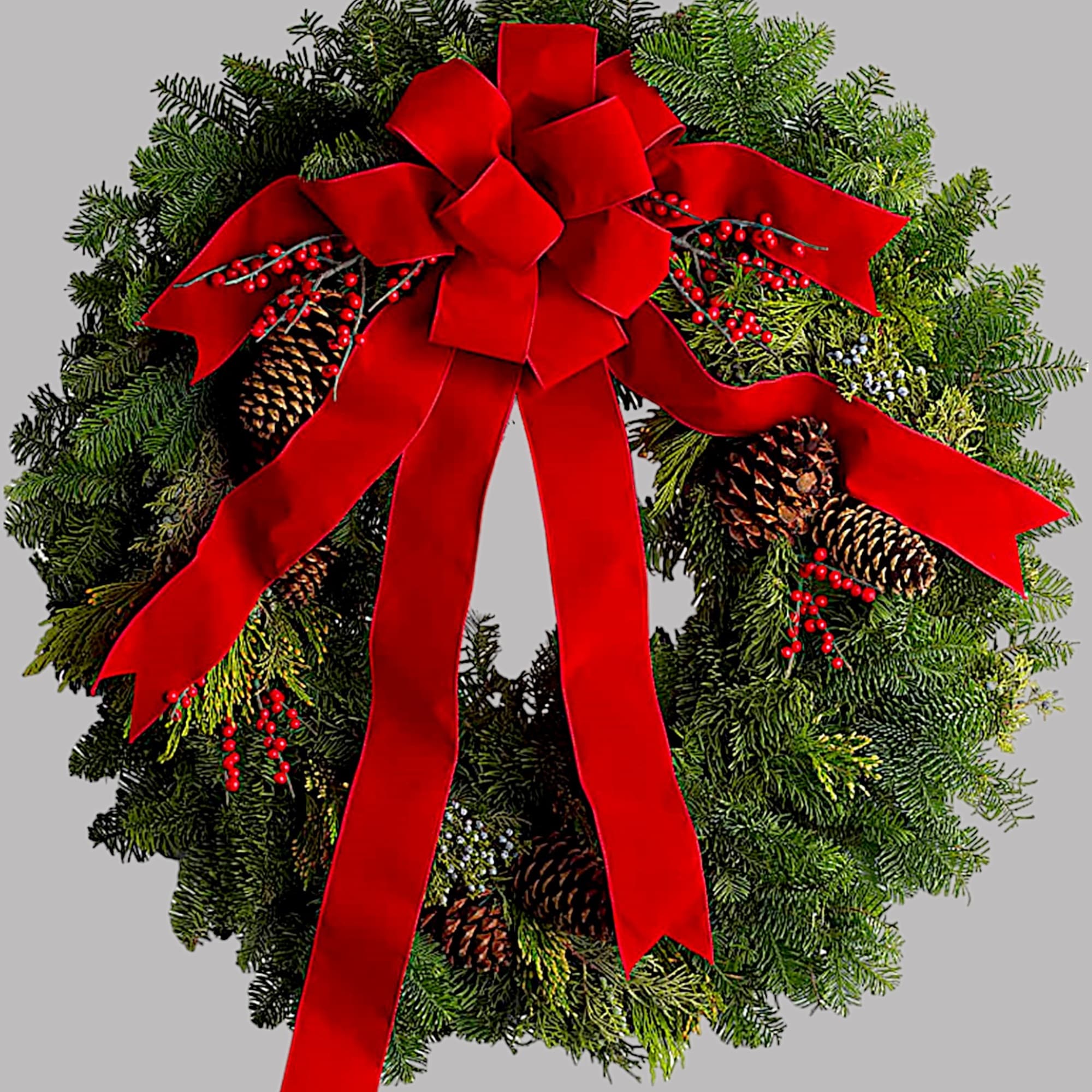 Evergreen wreath with a large red bow and pinecones