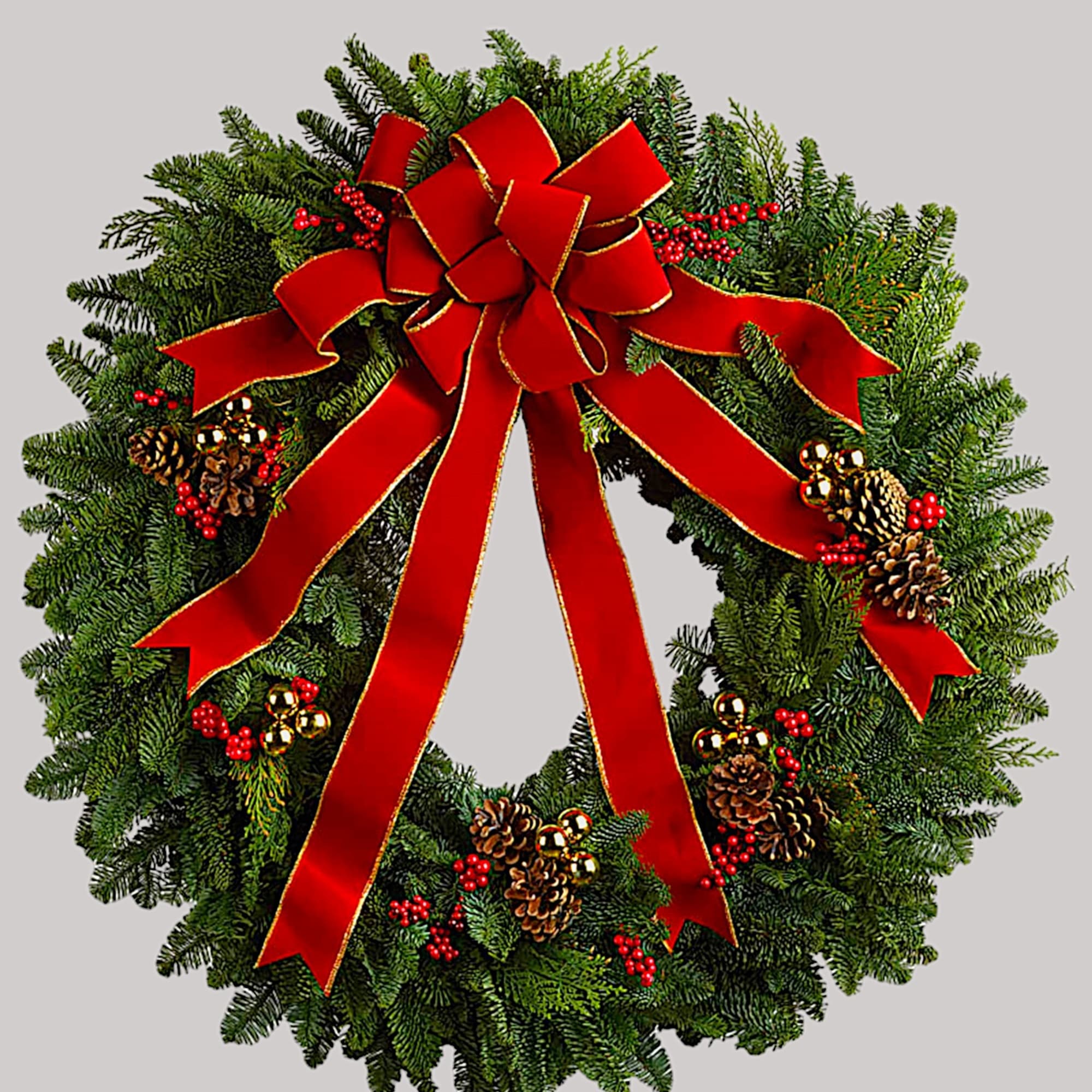 Christmas wreath with a red bow, pinecones, and berries