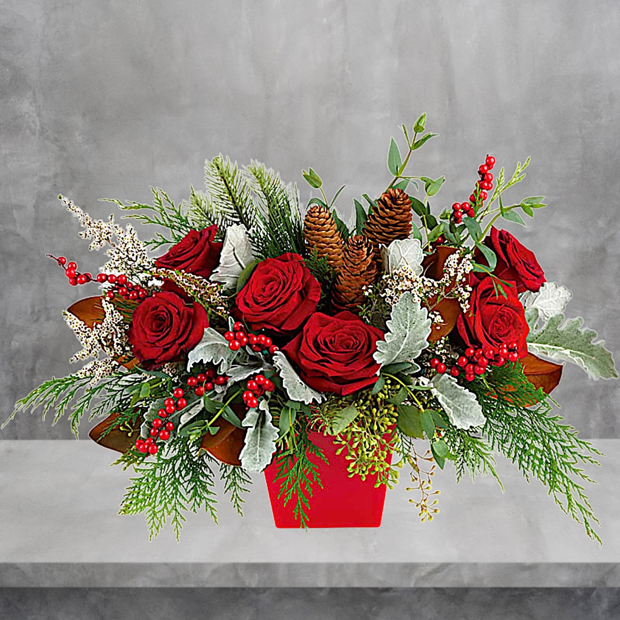 Red roses in a red container with pinecones and berries, photo 2 of 3