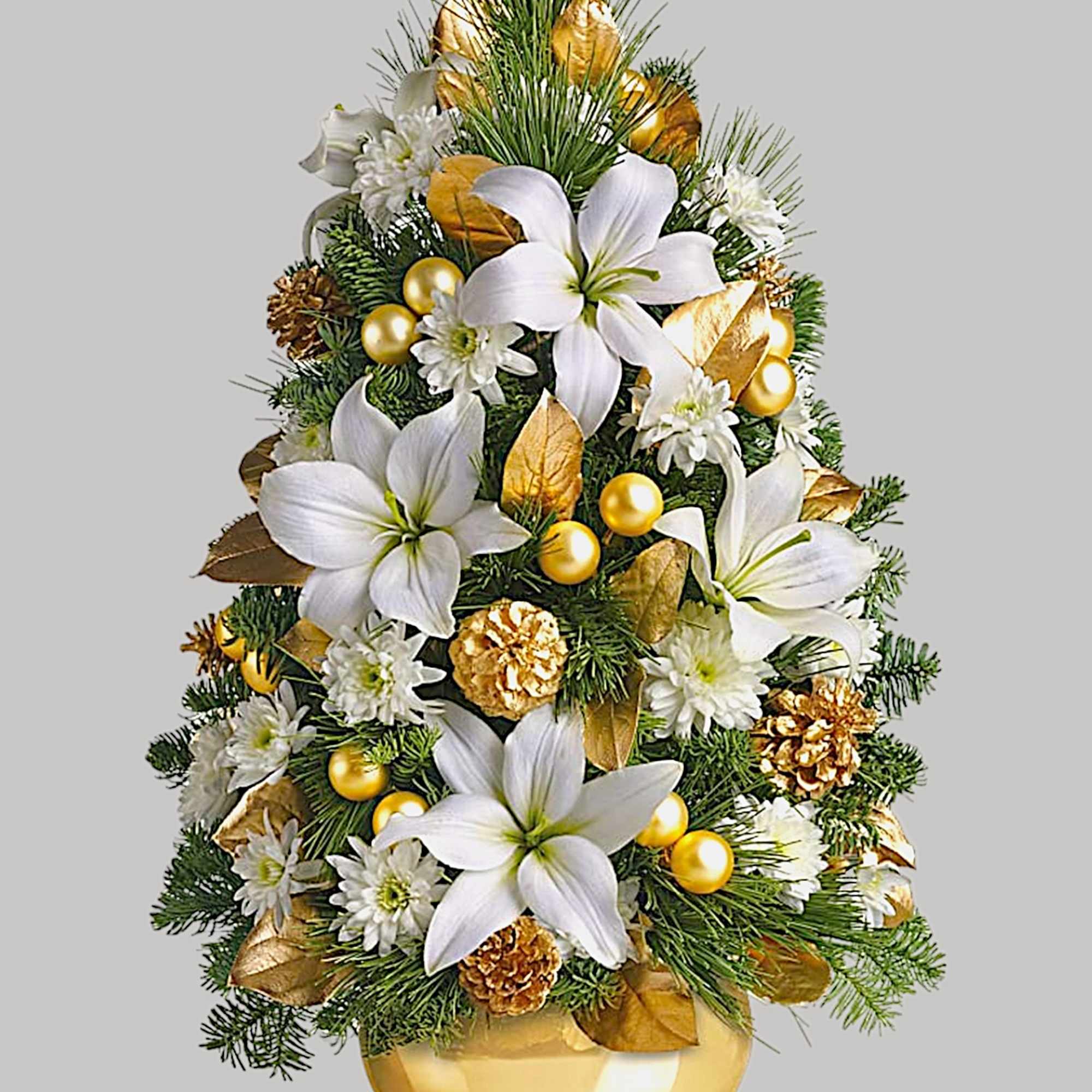 Christmas tree-shaped floral arrangement in a gold vase with white lilies