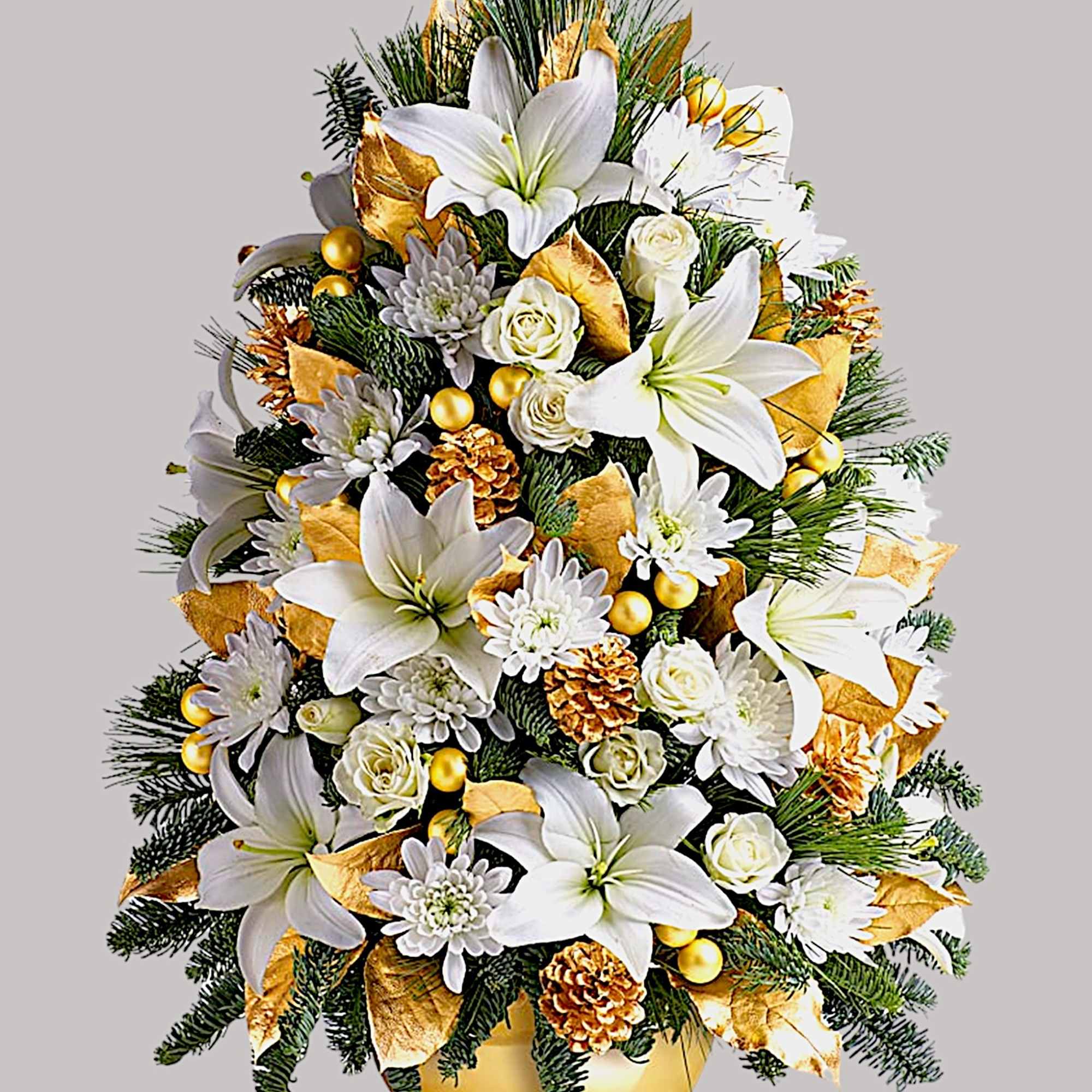 White lilies and roses arranged with gold accents in a gold vase