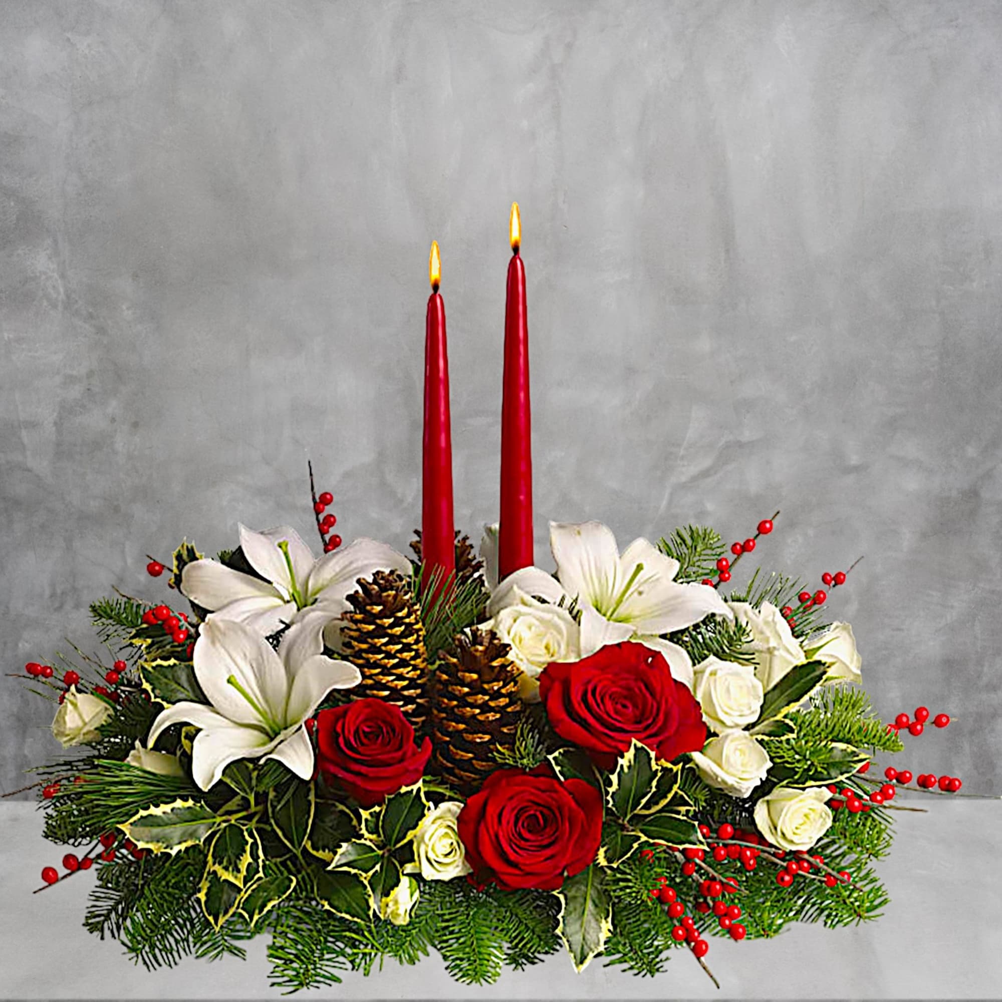 Holiday centerpiece with red candles, roses, lilies, and pinecones, photo 2 of 4