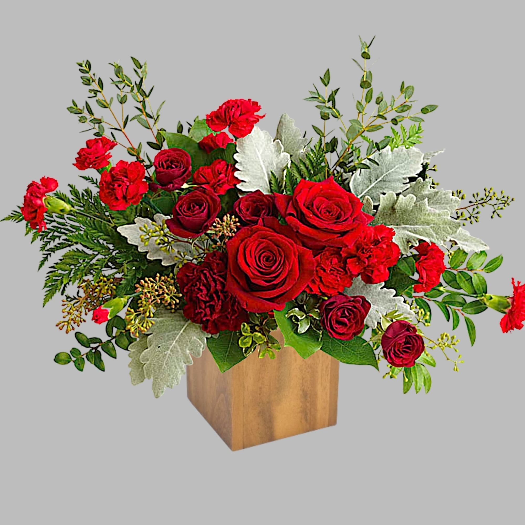Red roses and carnations in a wooden cube vase
