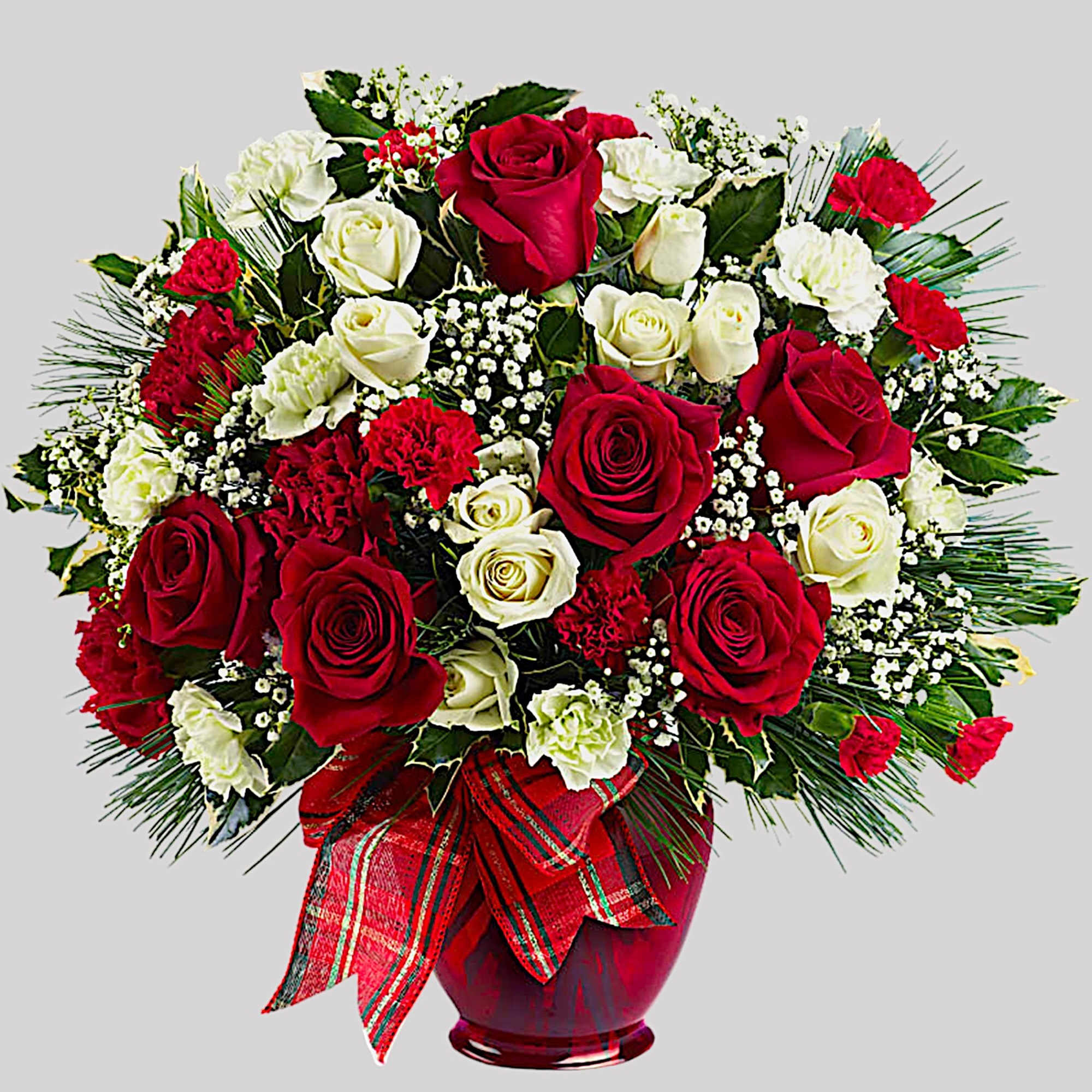 Red and white roses with carnations in a glass vase
