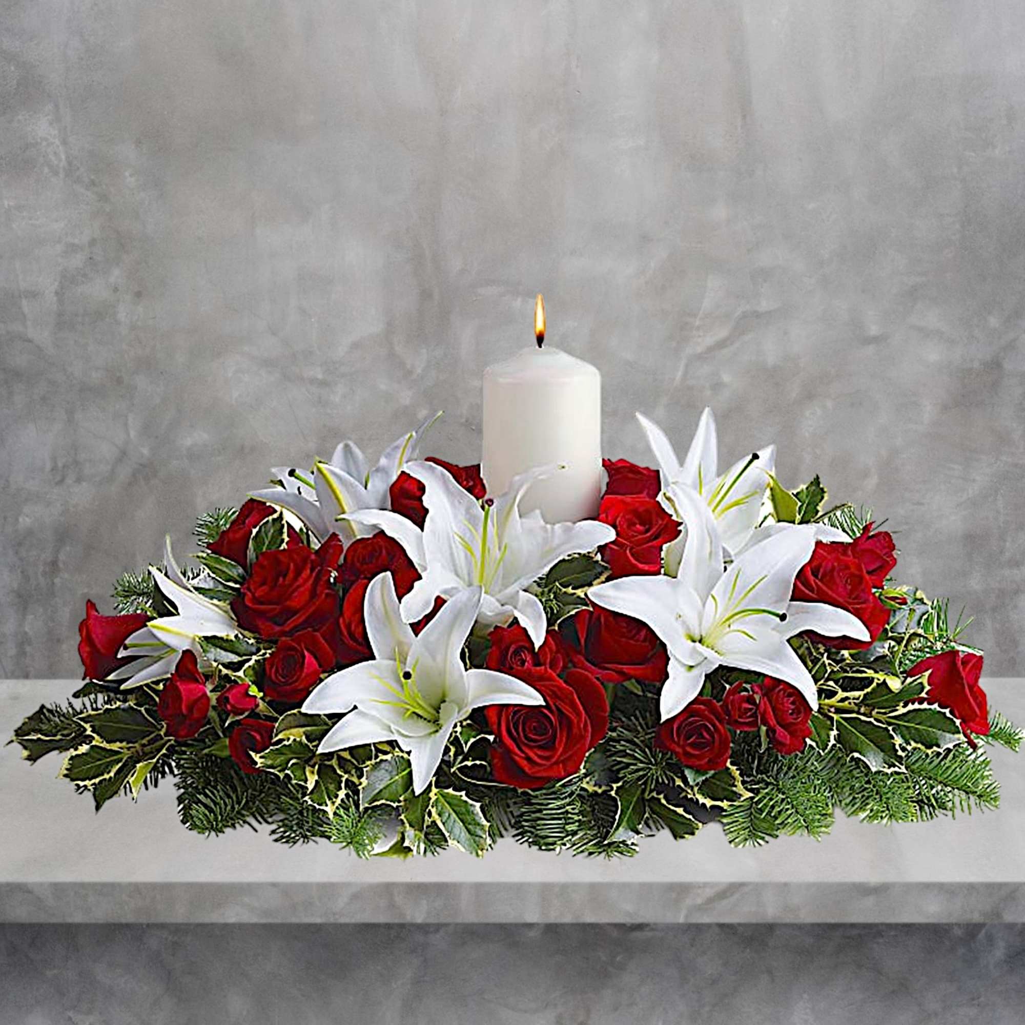Red roses and white lilies arranged around a lit white candle, photo 2 of 4