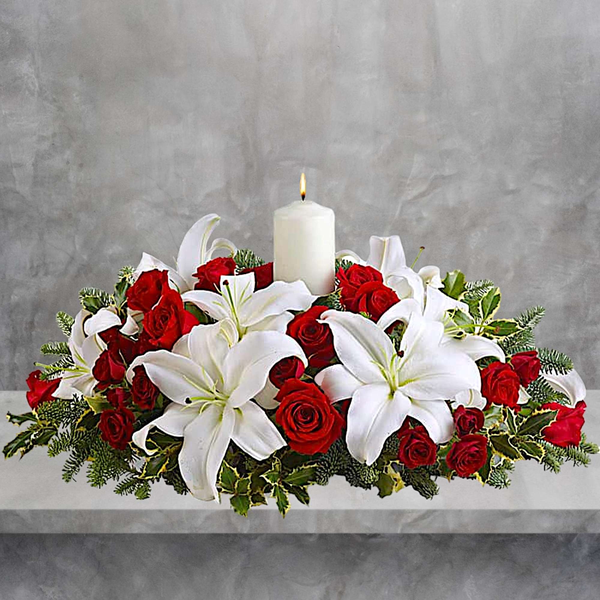 Red roses and white lilies arranged around a lit white candle, photo 2 of 4