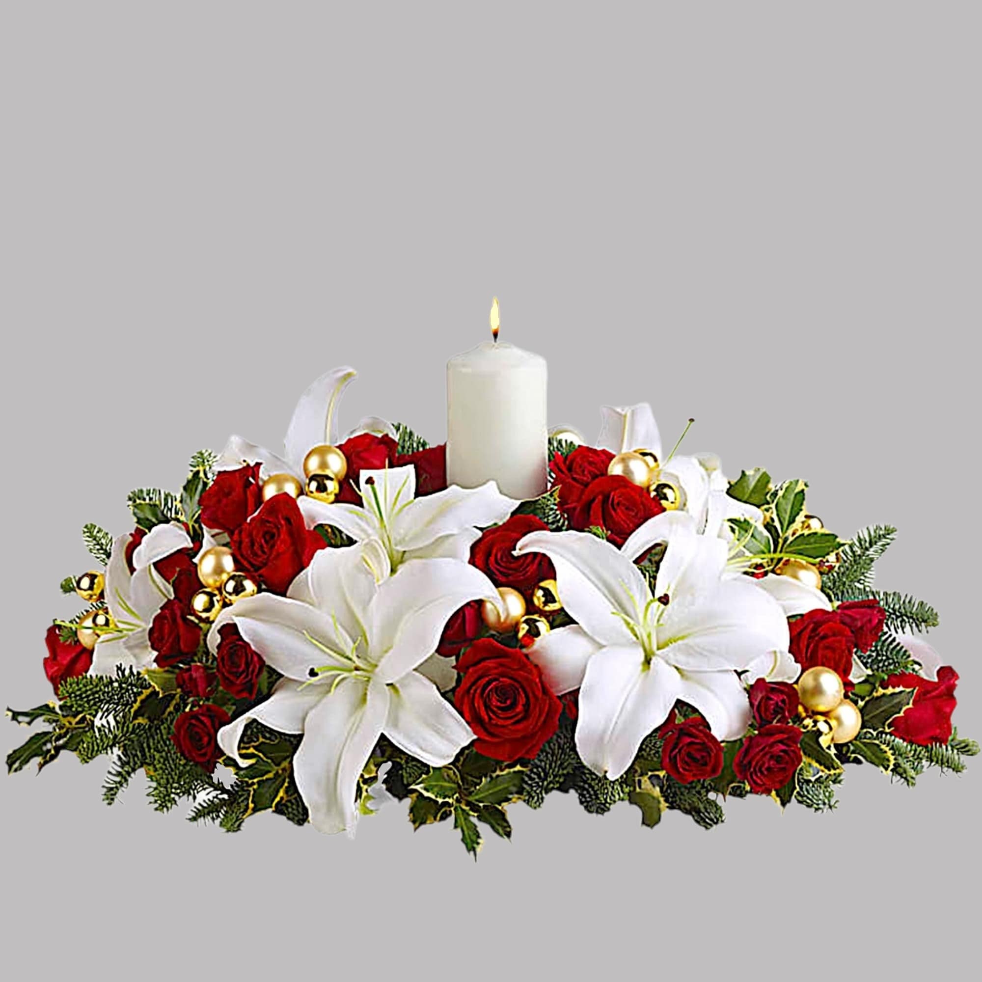 Red roses and white lilies arranged around a lit white candle, photo 4 of 4