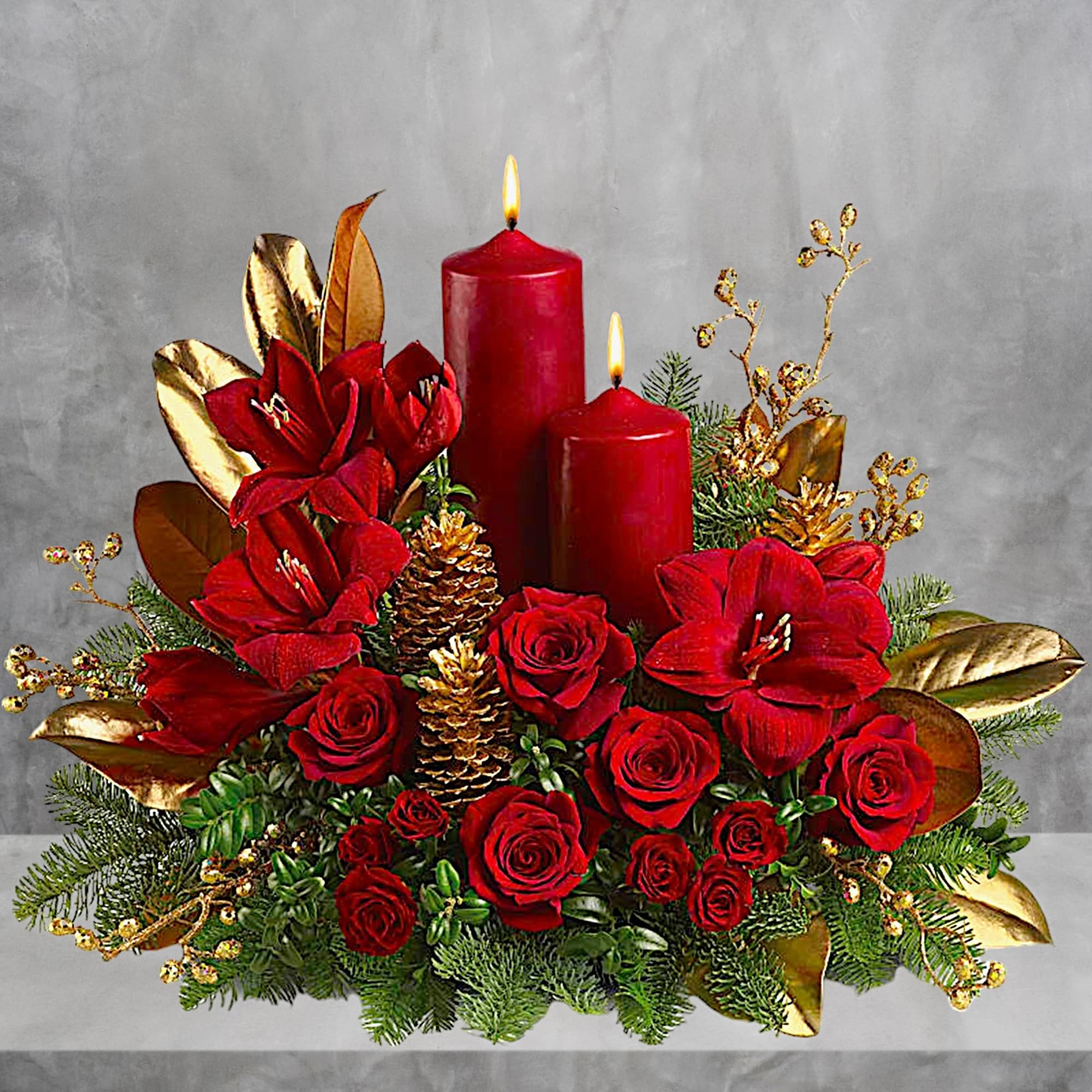 Red floral centerpiece with candles and gold accents