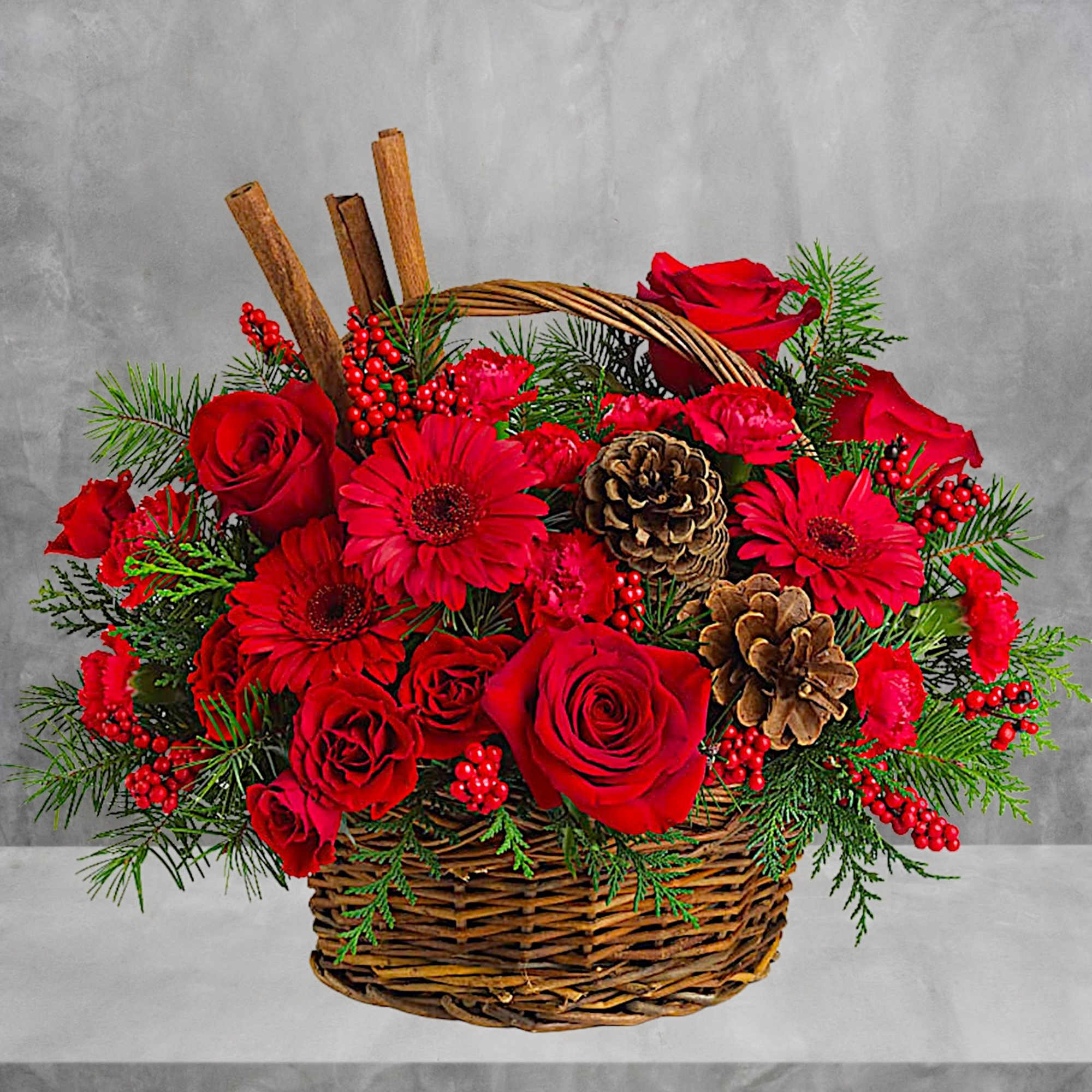 Red roses and gerbera daisies in a wicker basket with pinecones, photo 2 of 4