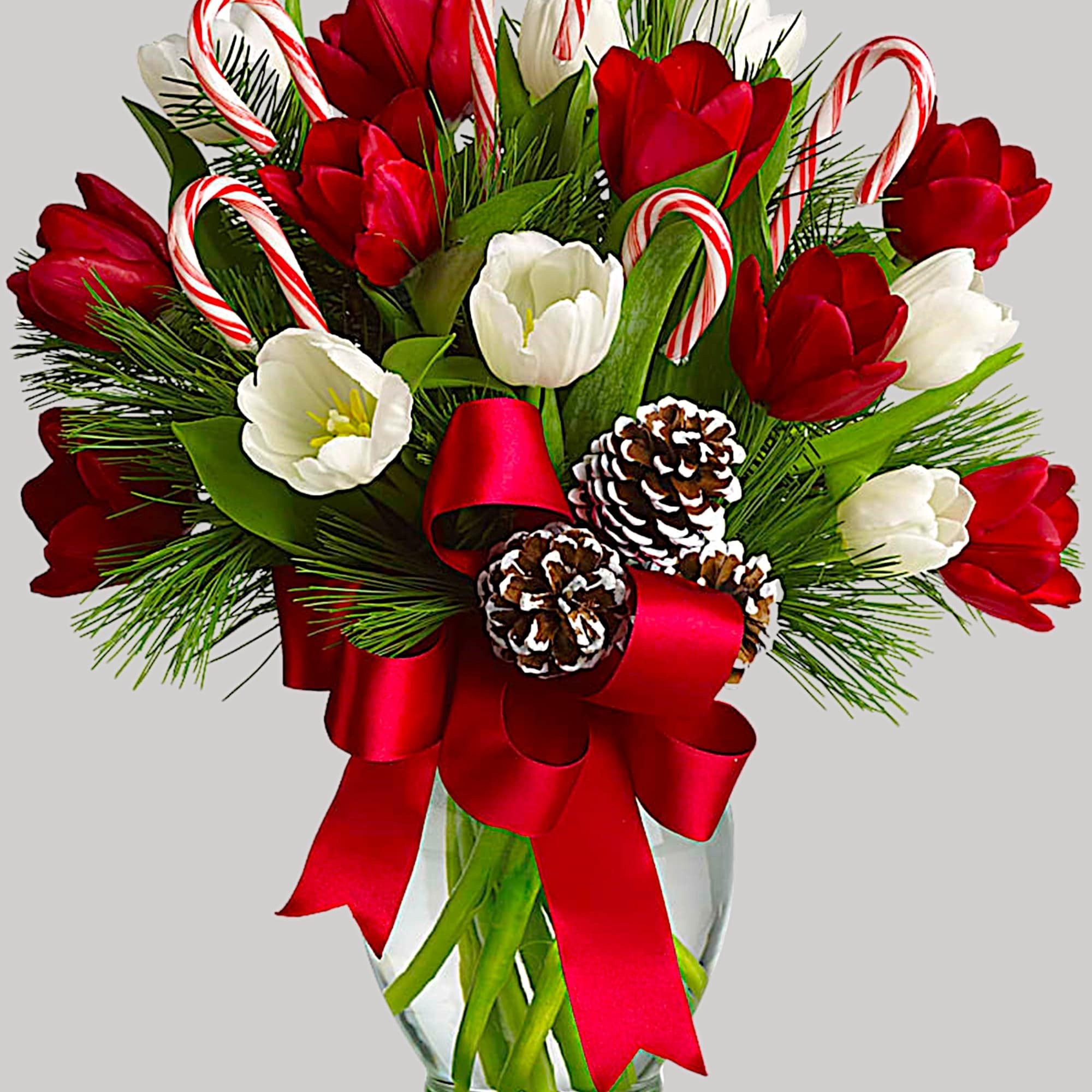 Red and white tulips in a glass vase with candy canes and a red ribbon, photo 4 of 4