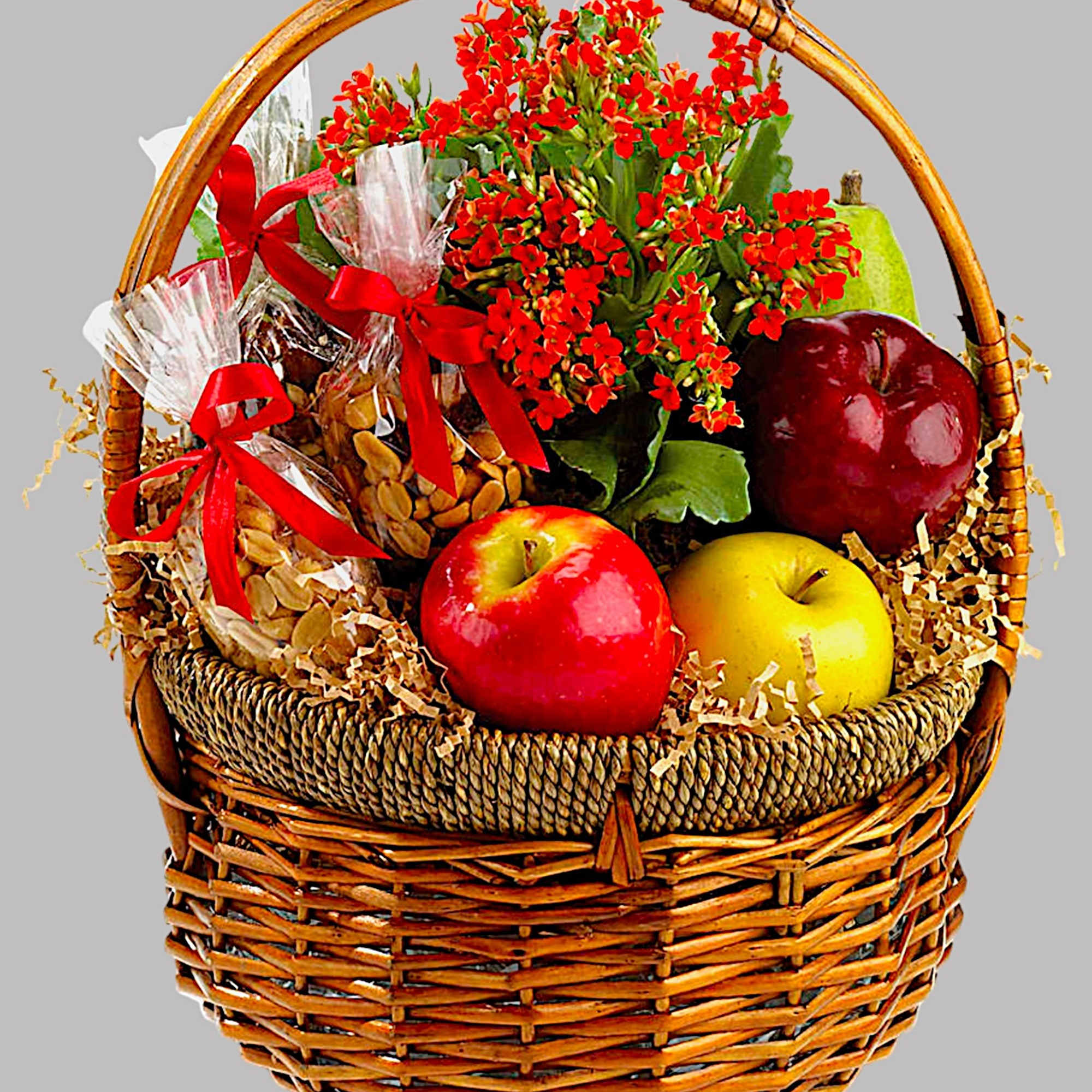 Basket of red flowers with fruit and wrapped snacks, photo 2 of 2