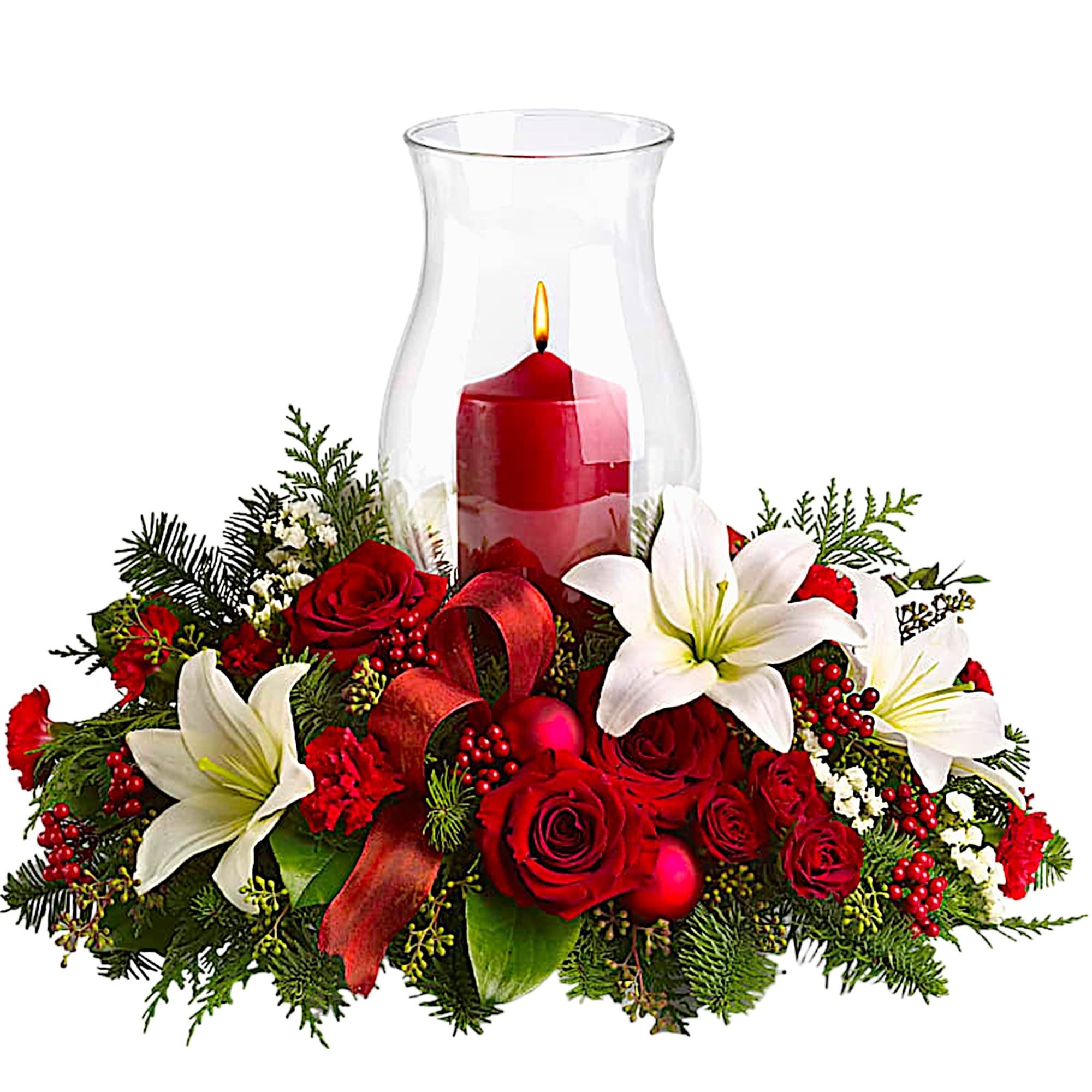 Red roses and white lilies arranged around a red candle in a glass hurricane