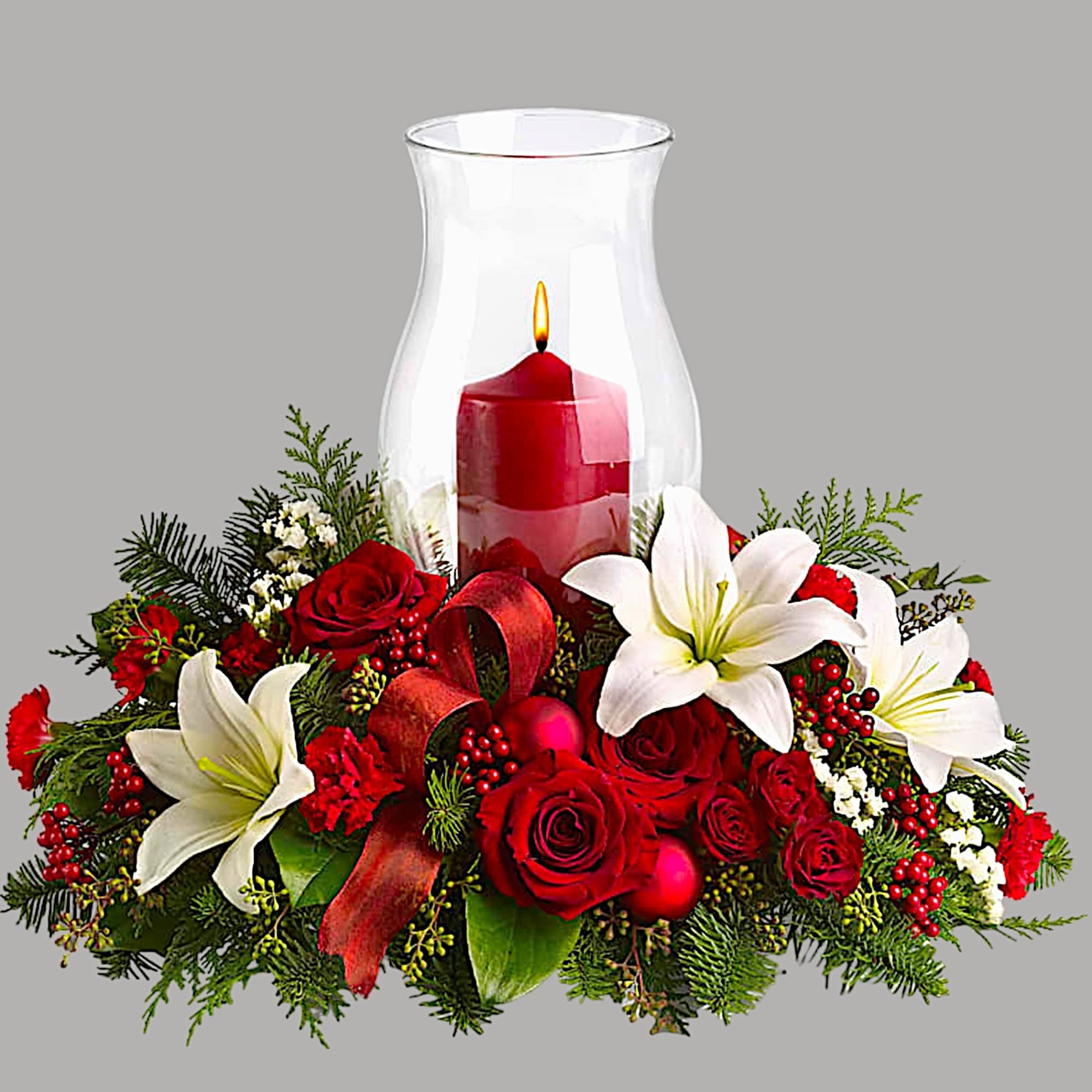 Red roses and white lilies arranged around a red candle in a glass hurricane, photo 4 of 4