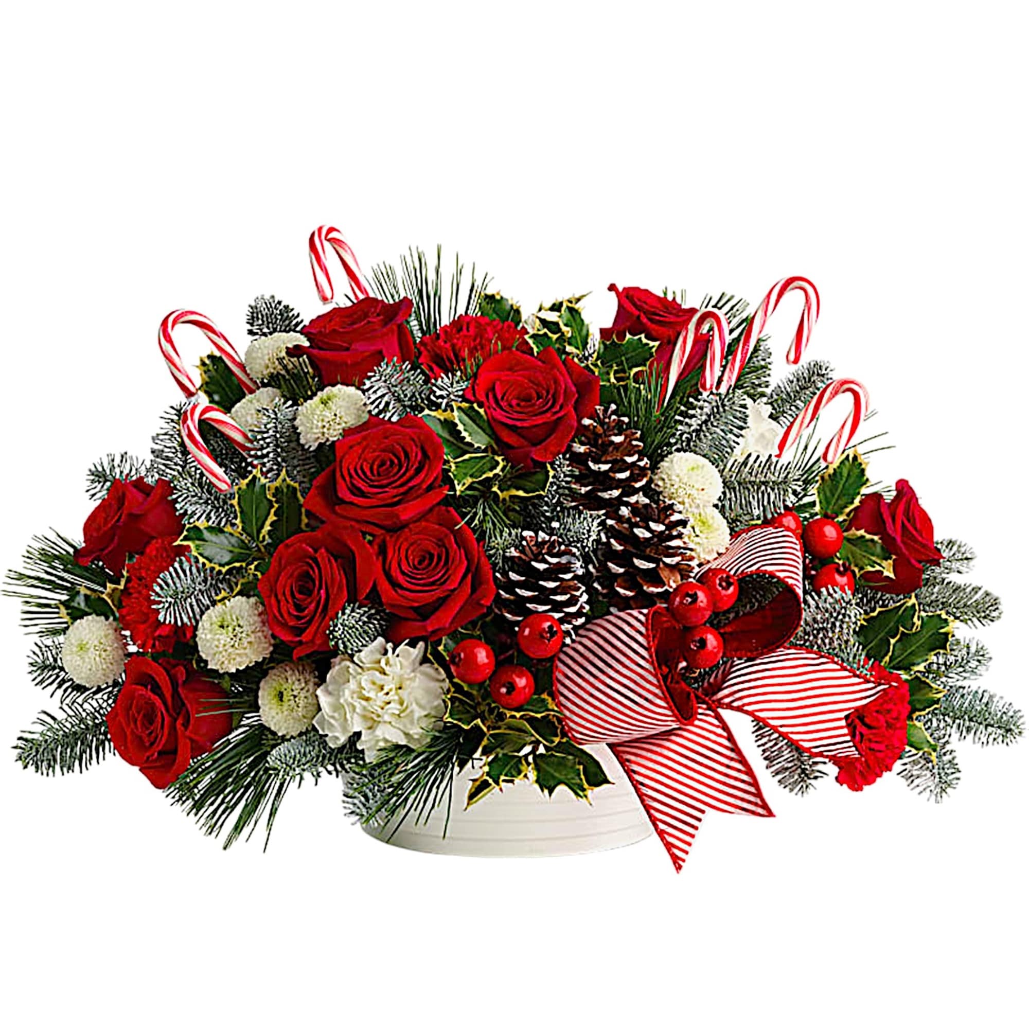 Red roses and white flowers in a white bowl with candy canes and ribbon