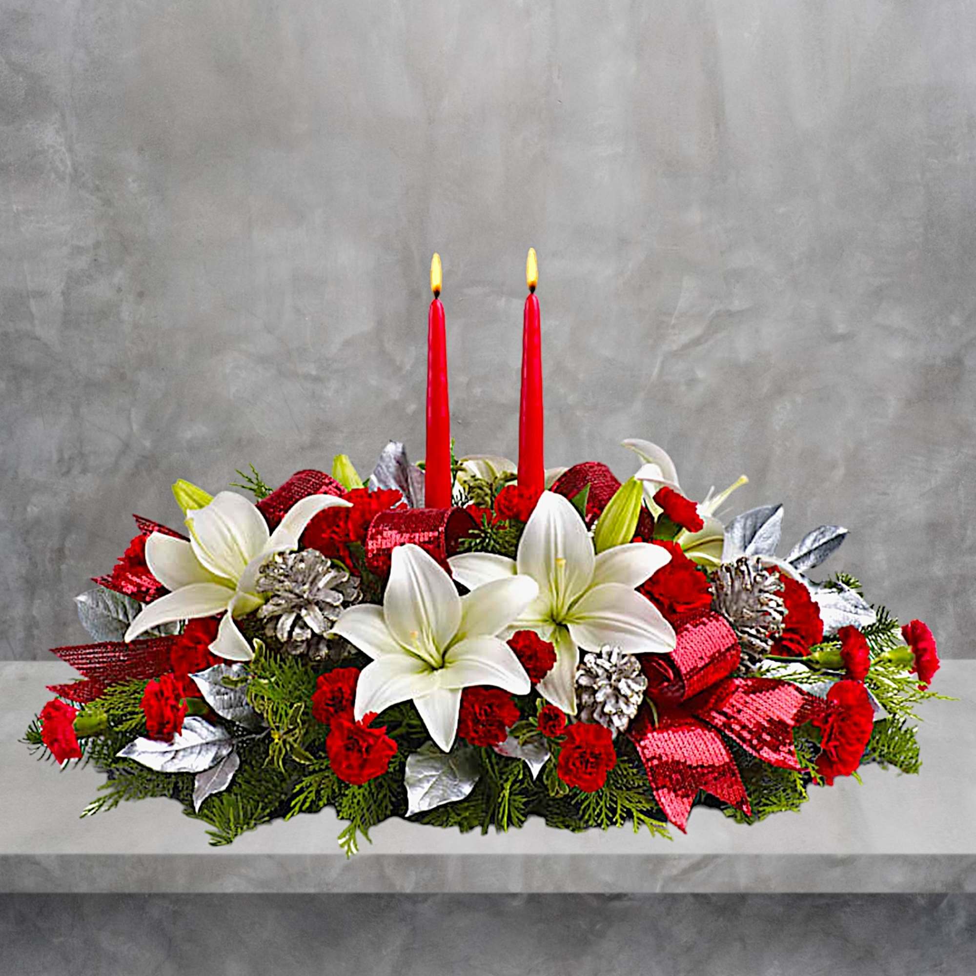Red and white floral centerpiece with two red candles