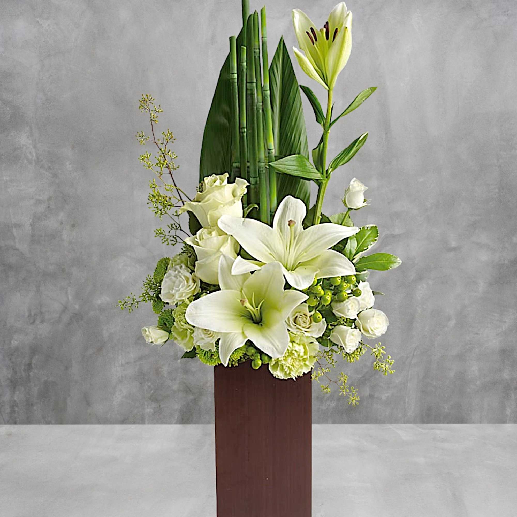 White lilies and roses in a tall wooden vase arrangement, photo 2 of 3