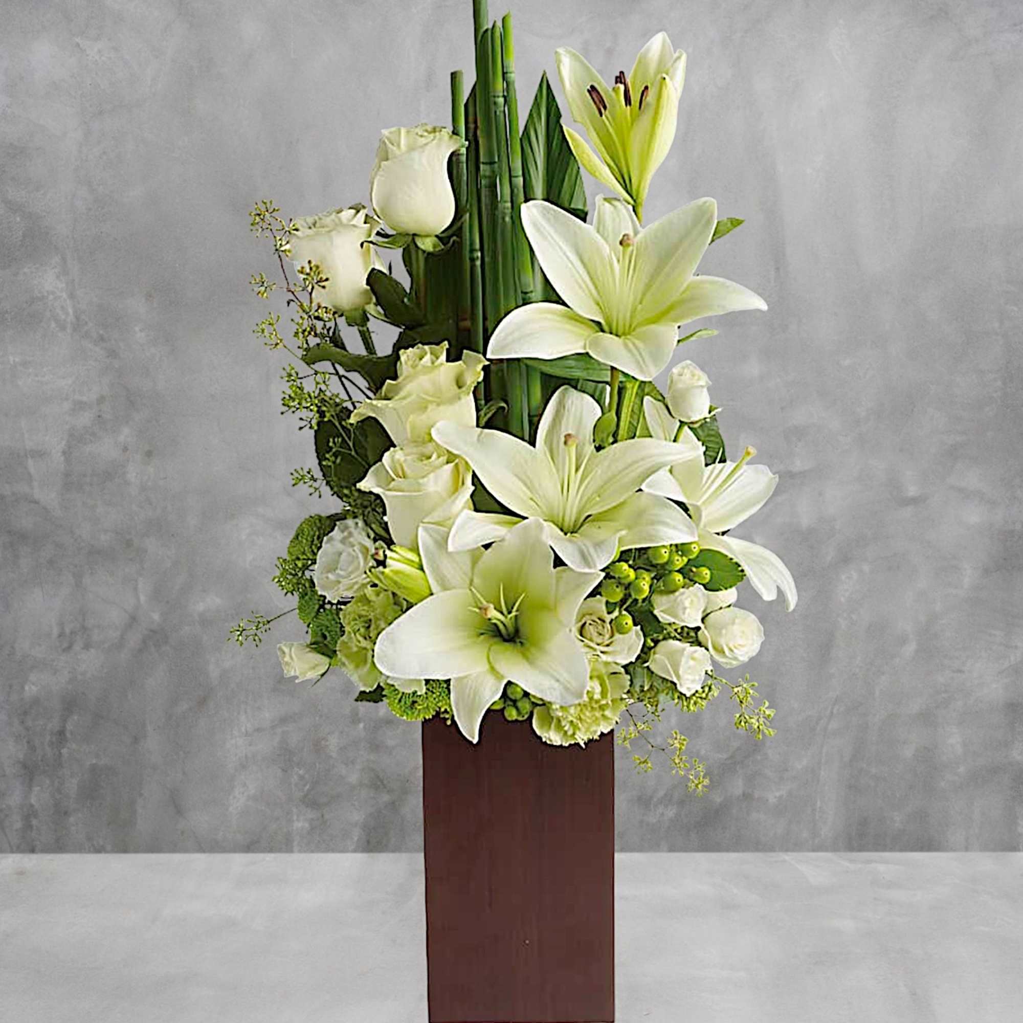 White lilies and roses arranged in a tall wooden vase, photo 2 of 3